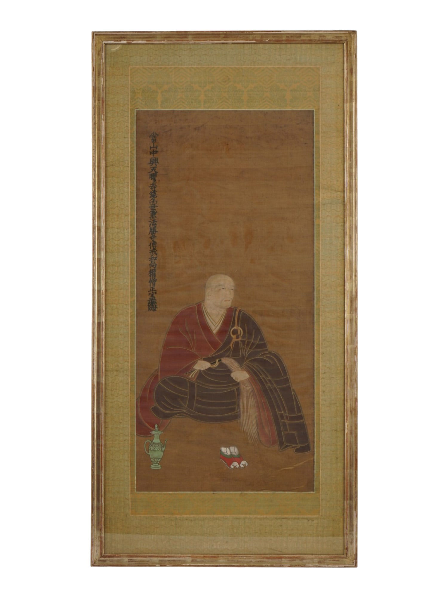 ANTIQUE JAPANESE BUDDHIST PORTRAIT SCROLL PAINTING: An antique Japanese hanging scroll painting on silk. Late Meiji era, before 1912. Chinso genre, a memorial or commemorative Buddhist portrait. The piece depicts a seated Buddhist monk with ceremonial