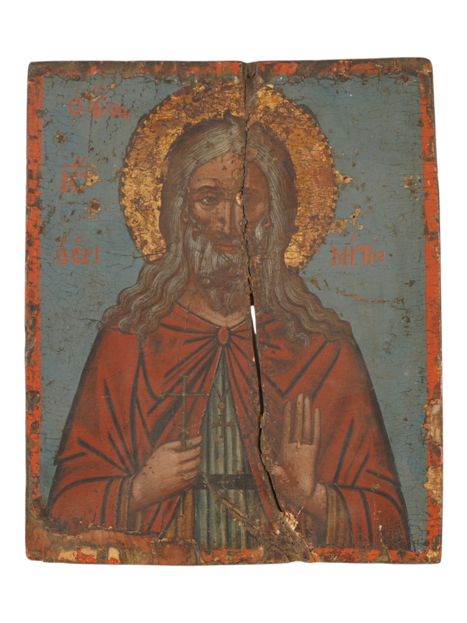 ANTIQUE EASTERN ORTHODOX ST. JOHN THE HERMIT ICON: An antique Eastern Orthodox painted wooden icon depicting a half-length bearded saint, possibly St. John the Hermit or a Holy Martyr. The figure is rendered wearing a red cloak over a dark, striped