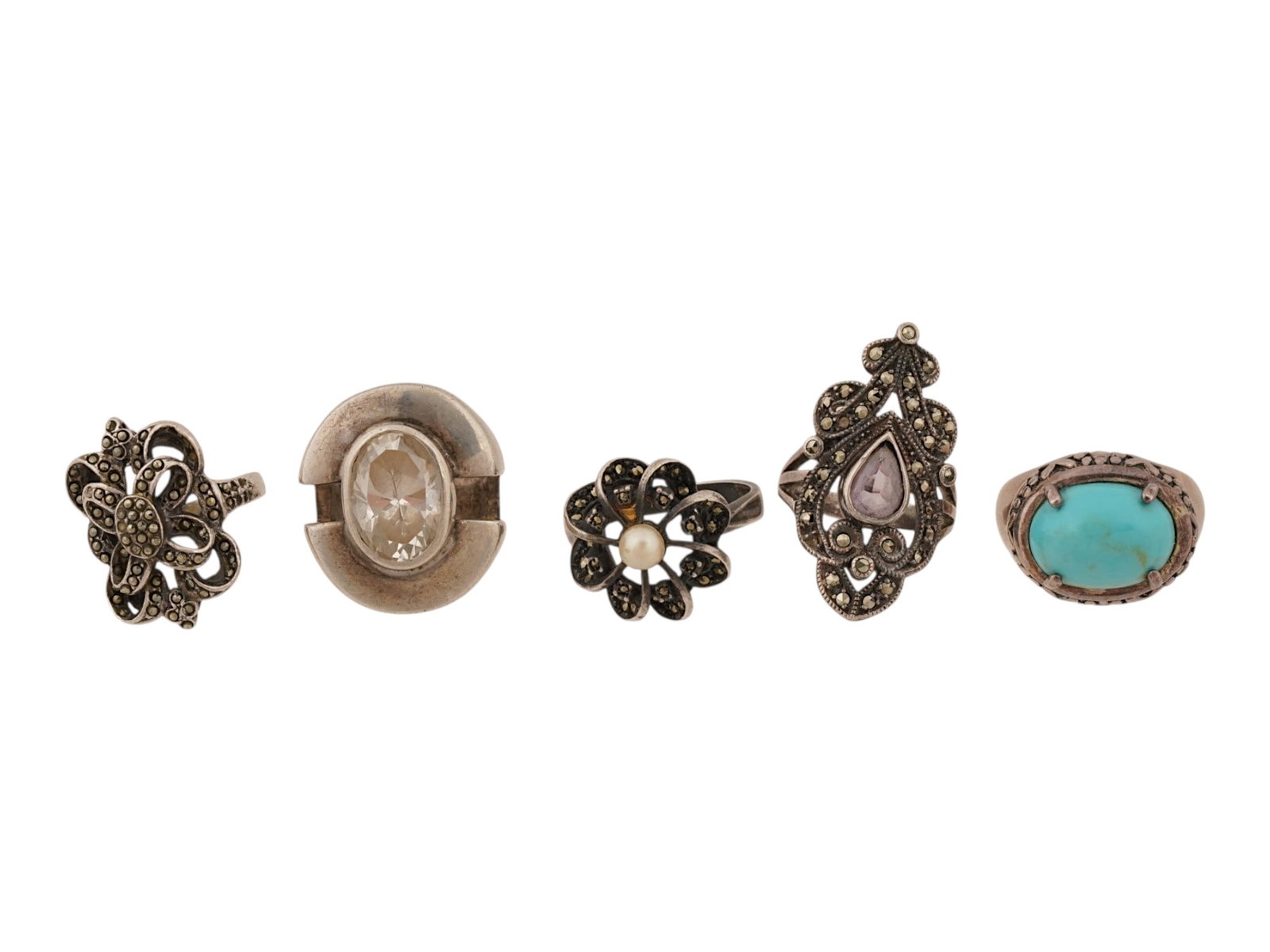 VINTAGE JEWELED STERLING SILVER STATEMENT RINGS: A lot of 5 vintage sterling silver statement rings of various design. The pieces are set with crystals, turquoise, pearls, and rivets. Marked 925 on the inside. Total Weight: 45 g. Sterling Silver, St