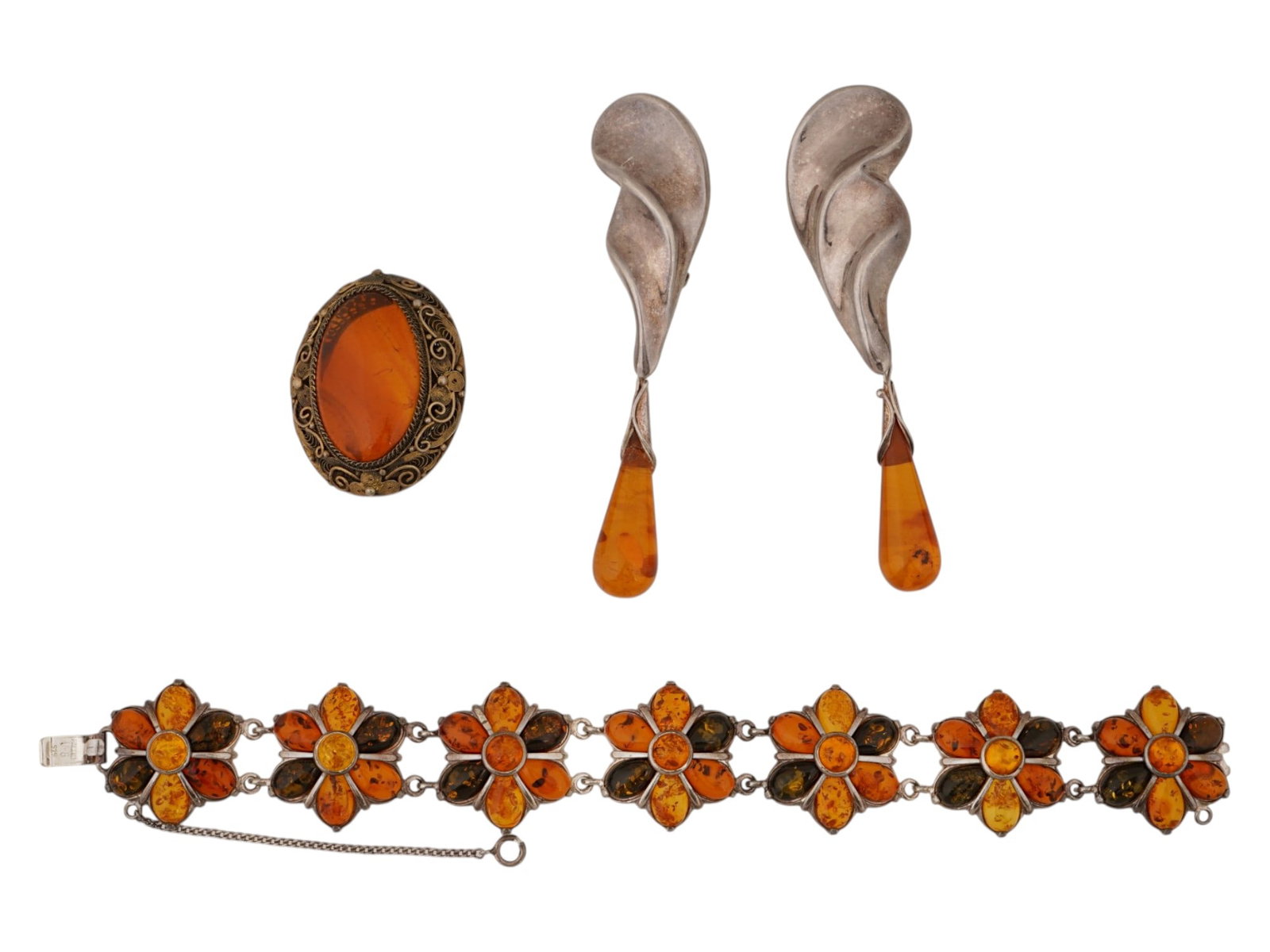 ST SILVER BROOCH BRACELET CLIP ON EARRINGS W AMBER: A group of vintage sterling silver jewelry with amber. The lot contains an oval brooch, a pair of Art Nouveau clip-on earrings, and a bracelet composed of amber flowers in various shades. The clip-on 