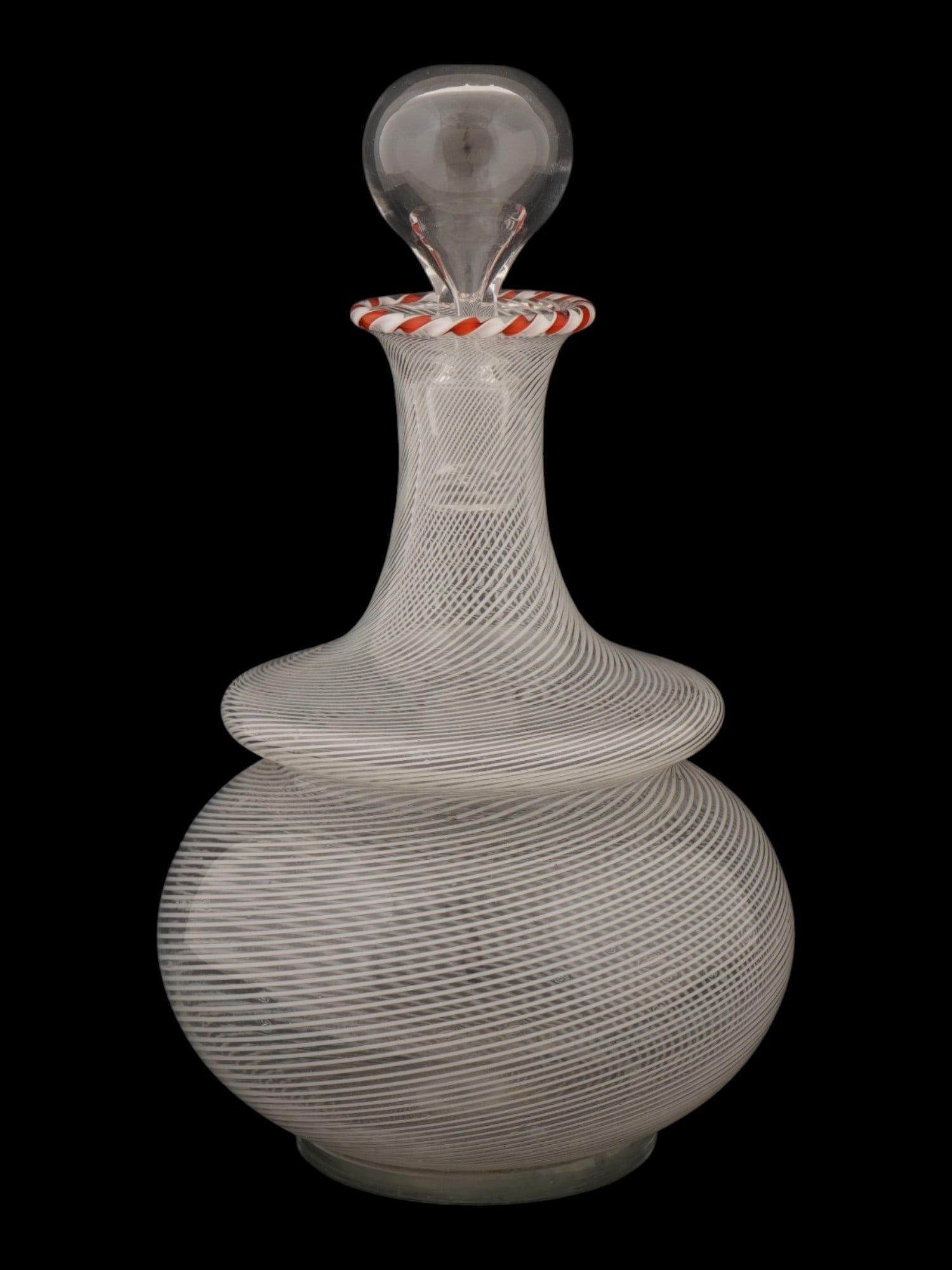 ITALIAN VENETIAN STYLE LATTICINO GLASS DECANTER: A vintage Italian Venetian-style blown glass decanter. Bulbous piece executed in latticino or filigrana technique: fine white glass threads are worked into the clear glass body in a criss-crossing spi