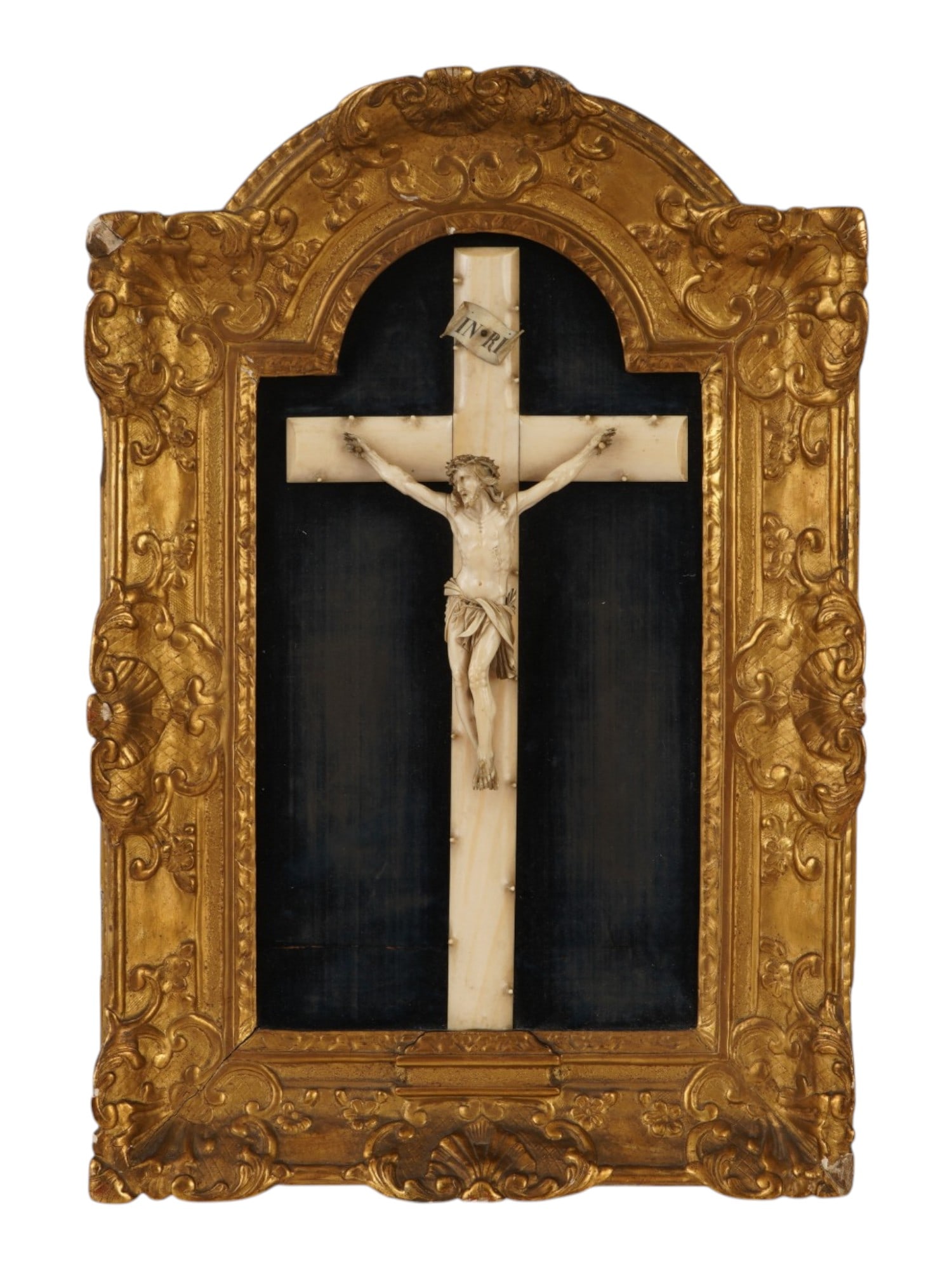 ANTIQUE CORPUS CHRISTI FRAMED CRUCIFIX: An antique crucifix with a figure of Christ Corpus Christi, carved from natural materials attached to a wooden cross. The crucifix is ??housed in a richly decorated, gold-toned Baroque wooden frame. A