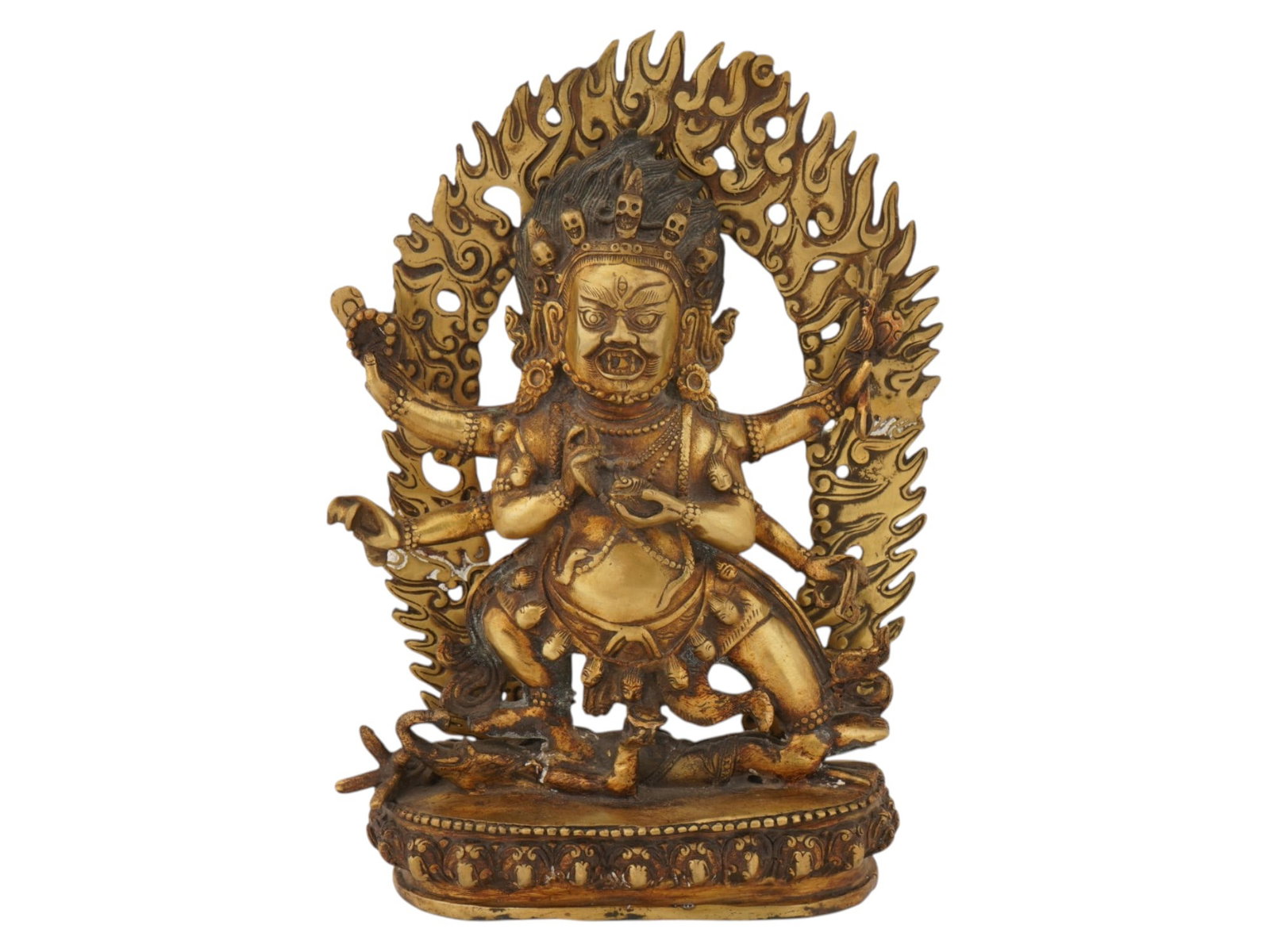 TANTRIC BUDDHIST GILT BRONZE FIGURE OF MAHAKALA: A vintage gilt bronze figure of Mahakala, a wrathful protector deity in Tantric Buddhism. Depicted with multiple arms, surrounded by flames, symbolizing the transformation of consciousness. Modern
