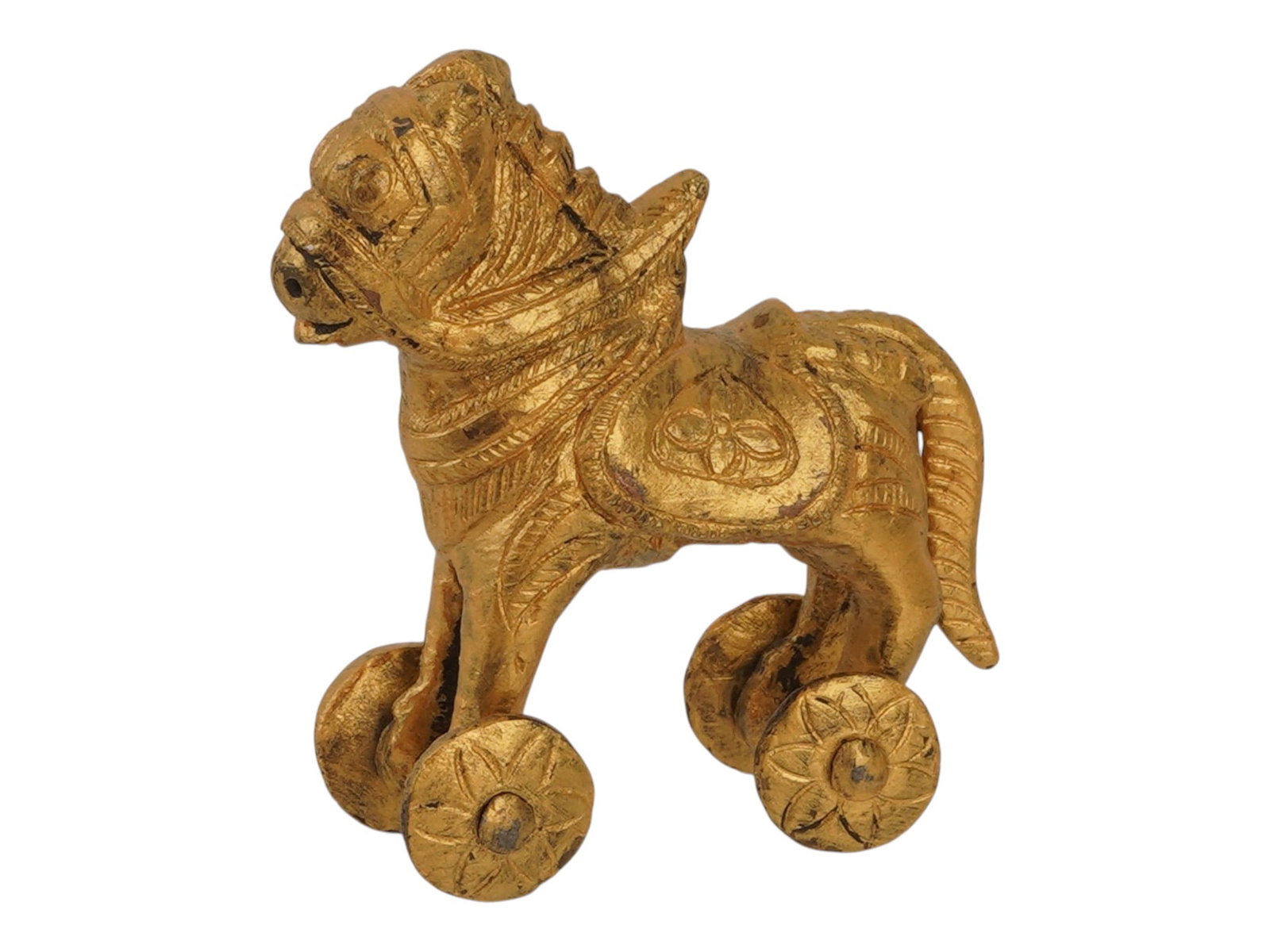 INDIAN BRASS TEMPLE TOY HORSE FIGURINE ON WHEELS: An Indian cast brass figurine depicting a caparisoned horse mounted on four circular wheels, characteristic of traditional Indian temple toys. The piece features intricate surface detailing,