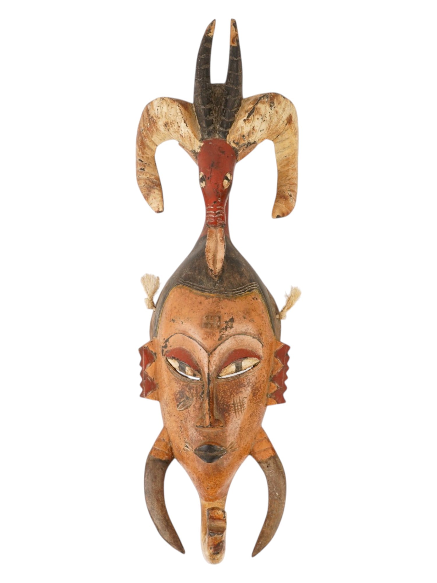 AFRICAN GURO CARVED WOOD ANIMAL MASK FROM IVORY COAST: An African Guro hand carved and hand painted dance mask from the Ivory Coast of Africa. The mask depicts spirit characters, Gu, Zamble and Zaouili with horns on the top, used in traditional ceremonies