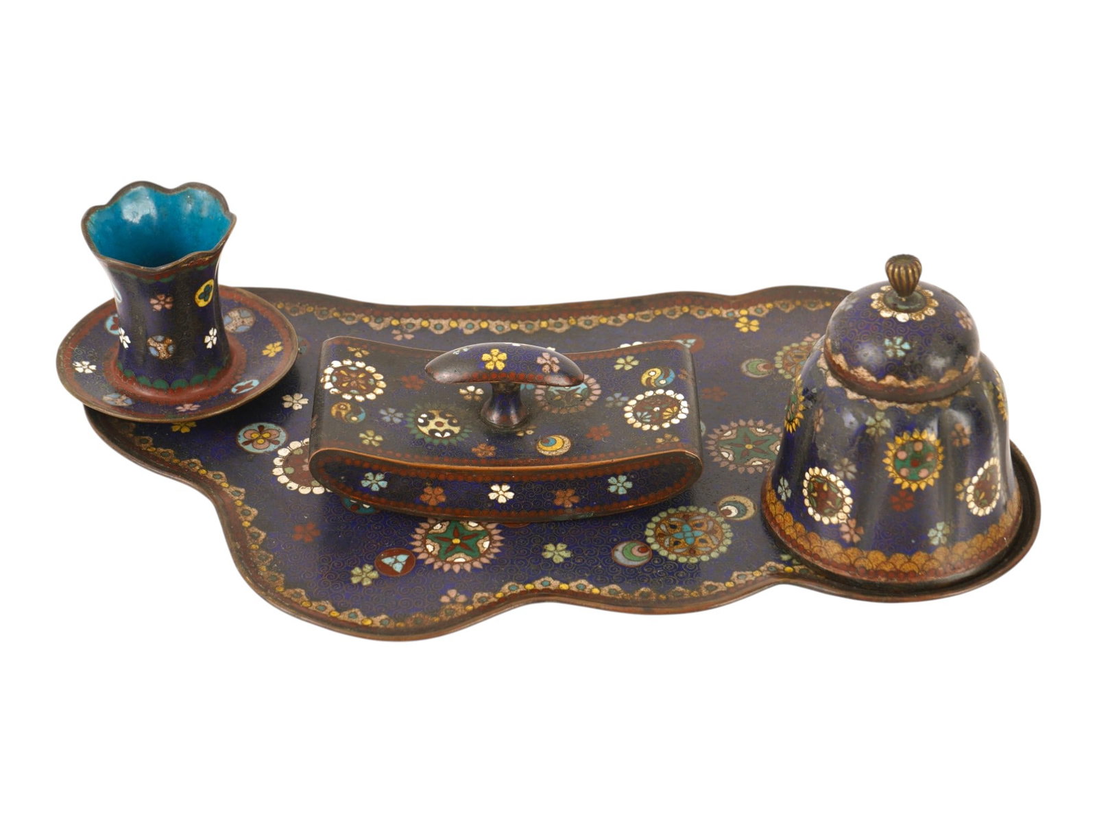 VINTAGE JAPANESE CLOISONNE ENAMEL DESK SET: A vintage Japanese cloisonne enamel desk set, comprising a scalloped writing tray with matching inkwell, rolling ink blotter, and pen or brush holder. Each piece features worked brass wire decoration 