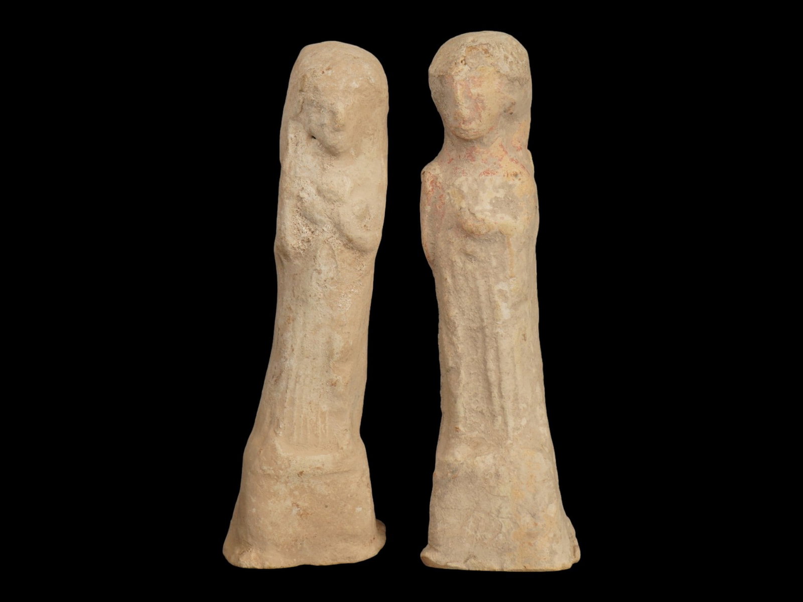 ANCIENT HOLY LAND TERRACOTTA GOD FIGURES 900 TO 700 BC: A lot of two ancient terracotta figurines from the Iron Age II period of the Holy Land, approximately 900 to 700 BC, representing the deities Baal and Astarte. Each figure is rendered in a stylized, c