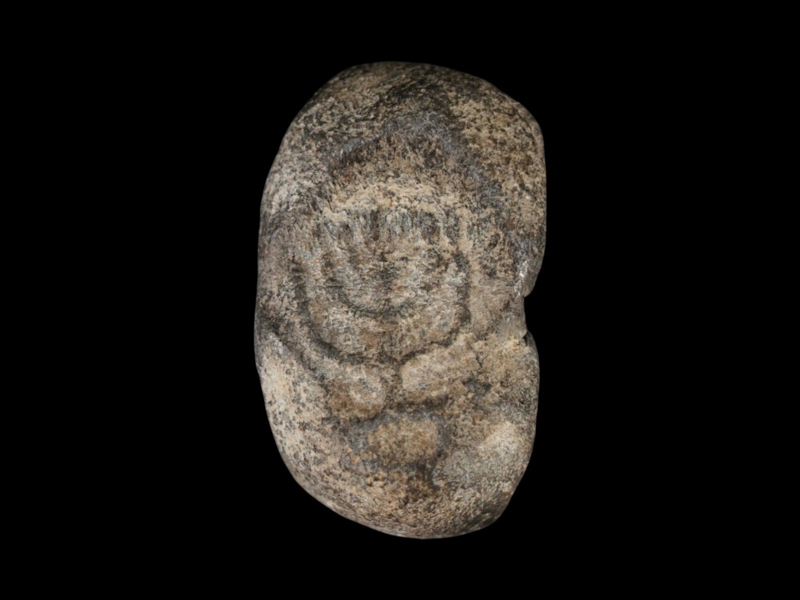 ANCIENT JUDAICA HOLY LAND FRAGMENT WITH A MENORAH MOTIF: An ancient Judaica Holy Land lead fragment stamped with a menorah motif, dating to approximately 200 to 400 AD. The piece bears an important symbol of Jewish religious tradition and reflects the mater