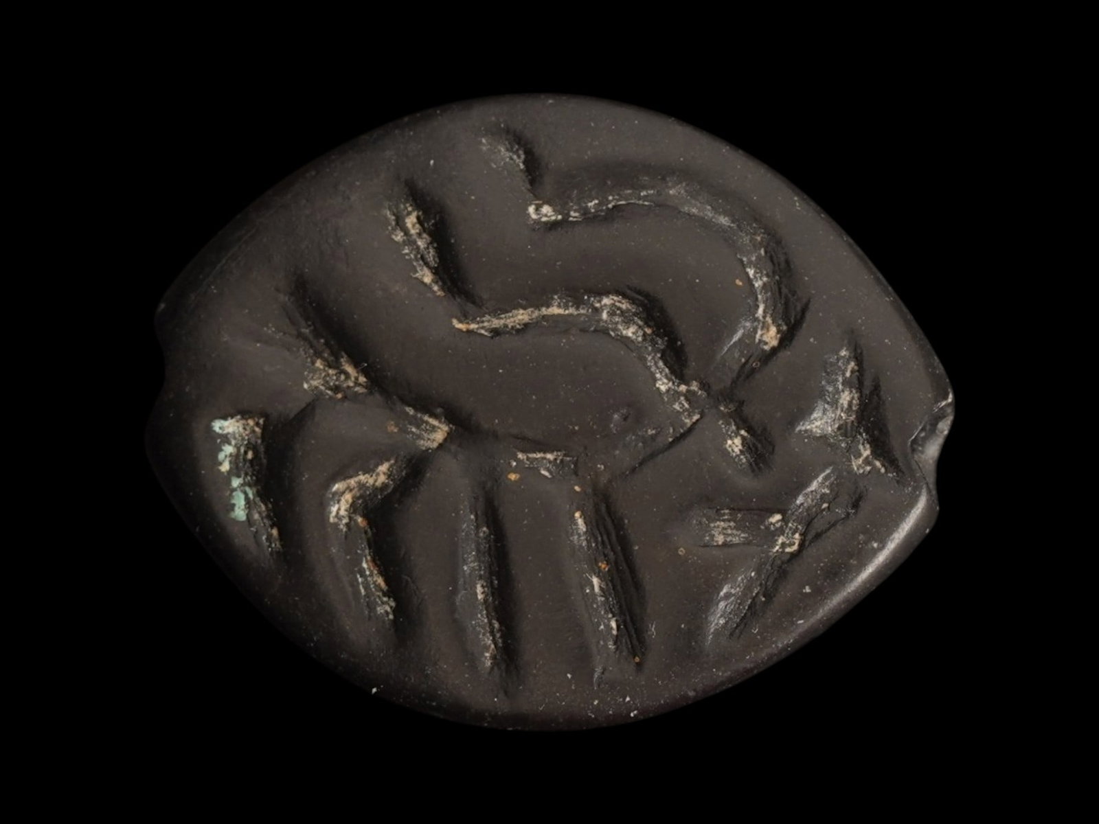 ANCIENT NEAR EASTERN STEATITE SEAL 2ND TO 1ST MILLENNIUM BC: An ancient Near Eastern black steatite stamp seal, dating to the 2nd millennium to the 1st Millennium BC, carved with a scene with a stylized animal in a field characteristic of early Mesopotamian gly