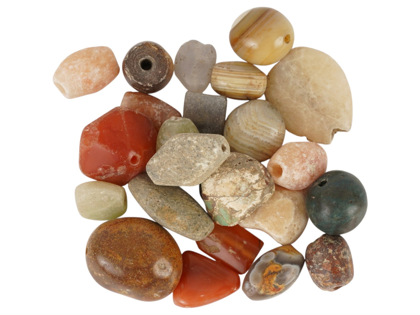 ANCIENT AGATE CARNELIAN STONE BEADS OF VARIOUS SHAPES: A group of ancient agate, carnelian, and related stone beads of various shapes, dating to the 1st millennium BC. Comprising a varied assortment of polished semi-precious stones in natural earth tones.