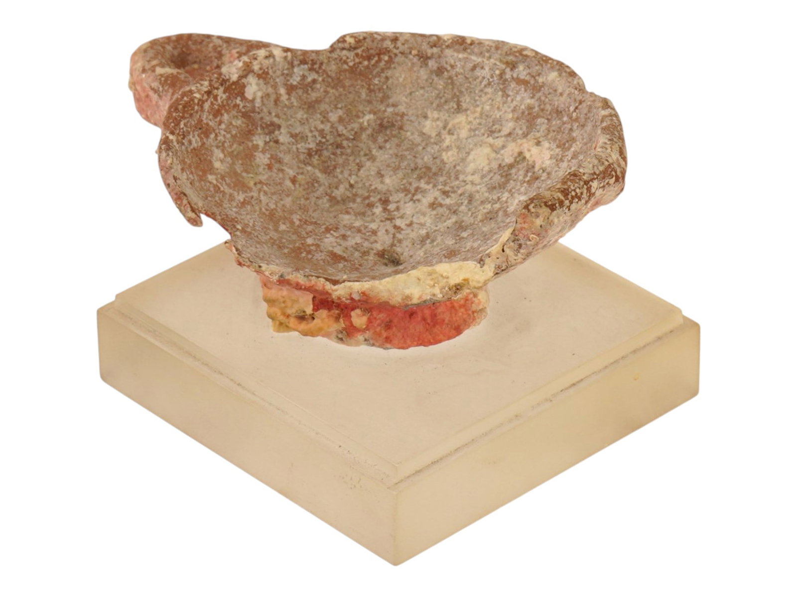 ANCIENT TERRACOTTA HANDLED CUP WITH A STAND: An ancient terracotta handled cup with a stand. The vessel features a flared rim and a single loop handle extending from the lip to the tapered lower body. The earthenware surface displays a variegate