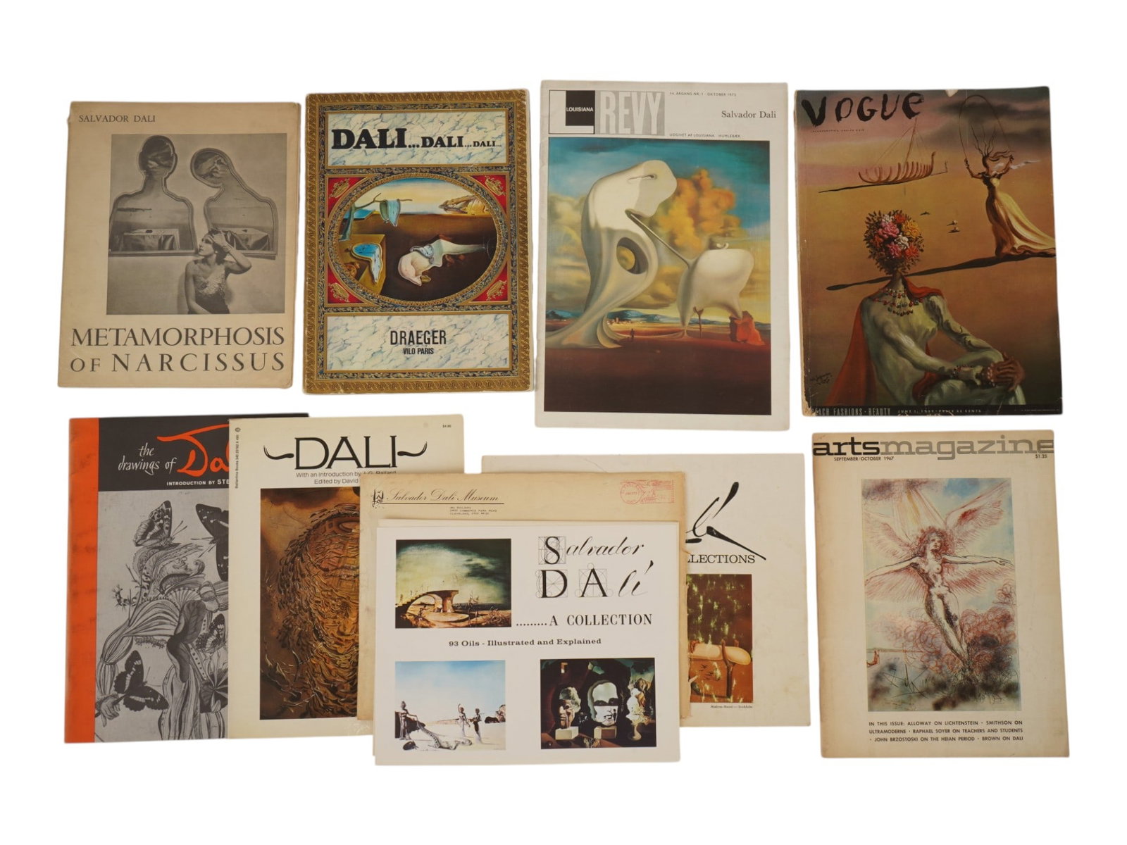 SALVADOR DALI ILLUSTRATED MAGAZINES AND BOOKS: Group of nine vintage books and magazines related to Salvador Dali. Louisiana Revy and Vogue magazines with covers executed by the artist, art catalogues and albums. The lot also includes a 1973 typew