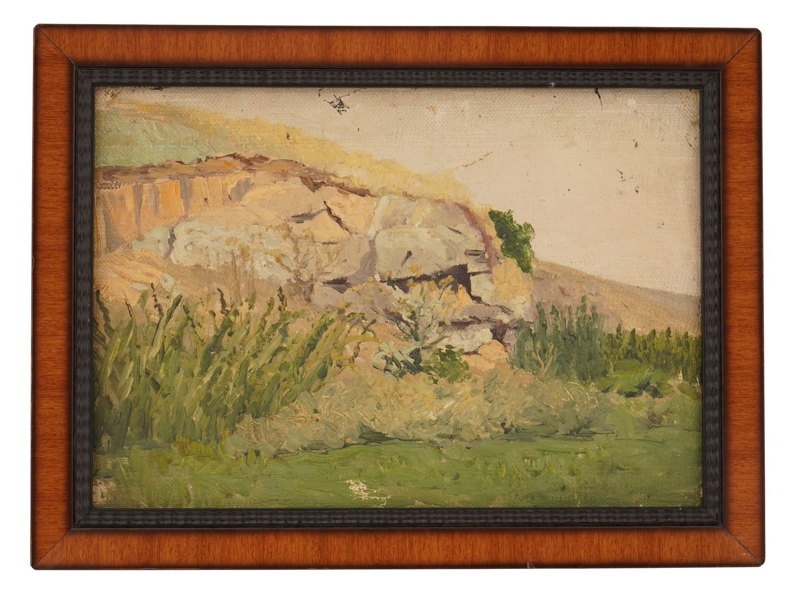 MODERNIST PLEIN AIR STYLE ROCKY LANDSCAPE OIL PAINTING: A 20th century oil painting on canvas depicting a landscape with a sunlit rocky bluff overlooking a verdant foreground of tall grasses and shrubs. Unsigned. Framed. Modernist and Contemporary Fine Art