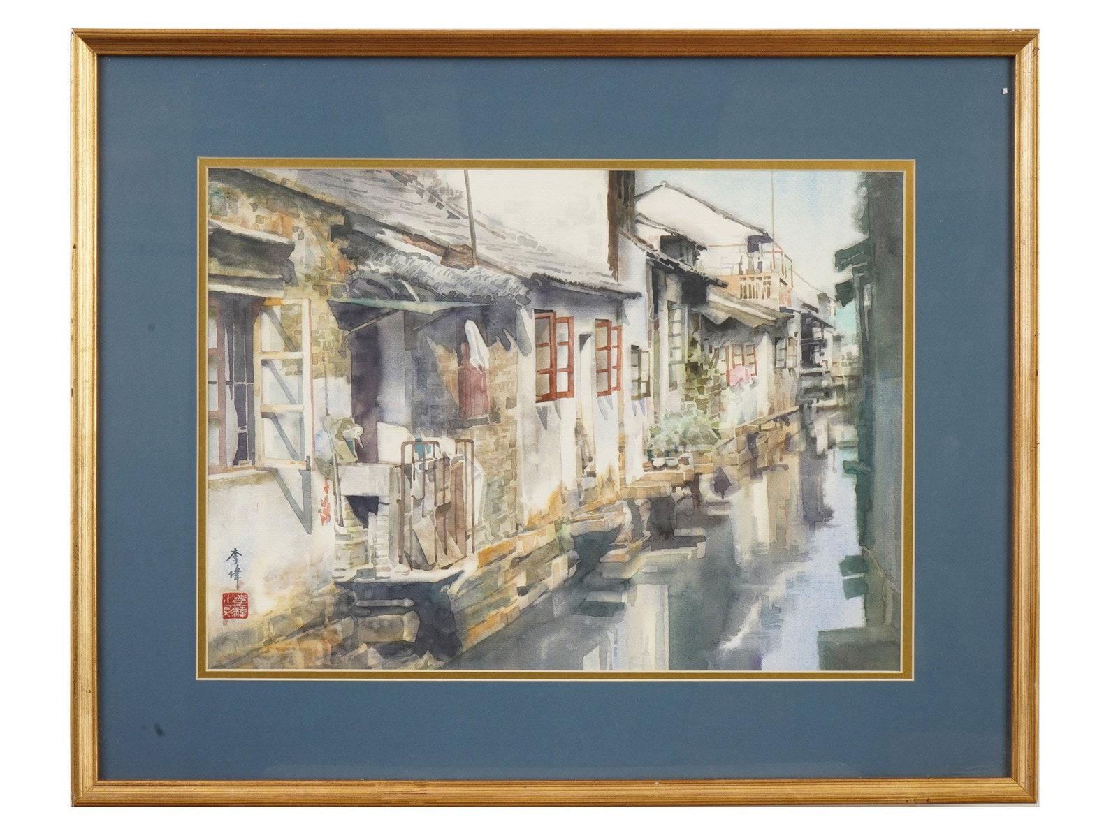 CHINESE WATER TOWN WATERCOLOR PAINTING SIGNED FRAMED: A Chinese watercolor painting on paper depicting a traditional Chinese water town, most likely one of the famous ancient cities of the Jiangnan region, such as Suzhou or Zhouzhuang. Signed with