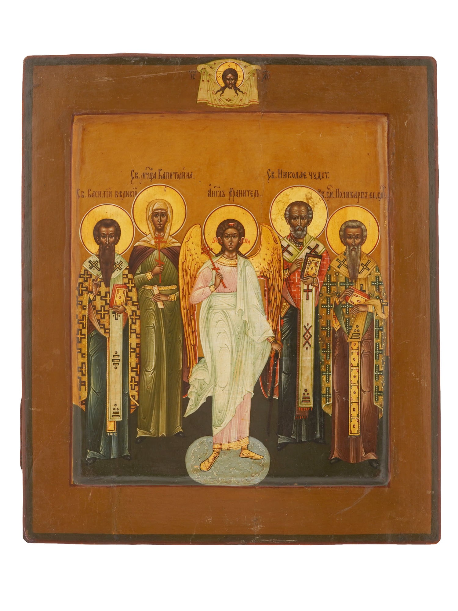 ANTIQUE RUSSIAN ORTHODOX ICON OF GUARDIAN ANGEL: An antique Russian Orthodox religious icon painted on a wooden panel, depicting a Guardian Angel surrounded by four selected saints. Dating to the 19th century. The composition includes the Holy