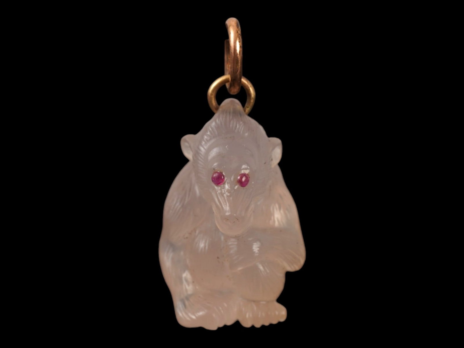 RUSSIAN 14K GOLD CARVED AGATE BABOON PENDANT W RUBY EYES: A Russian figural naturalistic hand carved Agate charm pendant modeled as a seated baboon. The figurine is adorned with engraved detailed patterns and encrusted with Ruby stone eyes. The pendant is mo