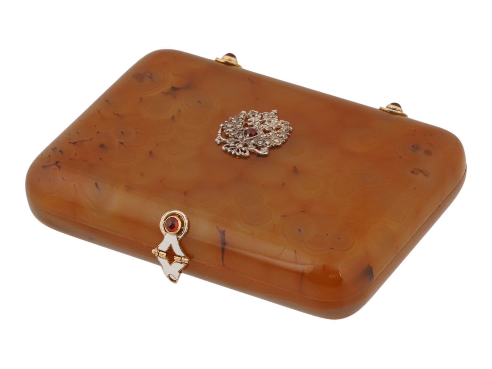 RUSSIAN GOLD AGATE RUBY AND DIAMOND CIGARETTE CASE: A Russian carved honey agate cigarette case with gold fittings. The lid is adorned with a relief overlay Imperial eagle set with diamonds. The hinges and clasp are adorned with white enamel and ruby