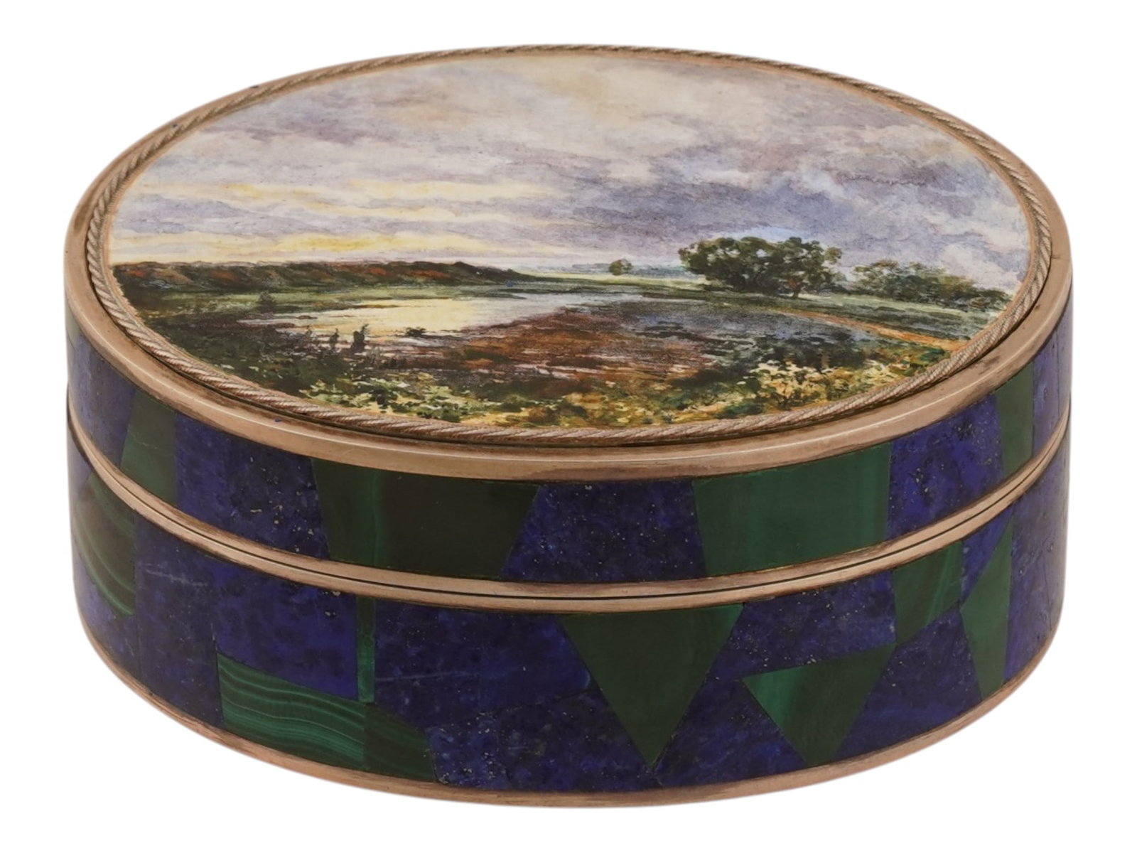 RUSSIAN GILT SILVER ENAMEL MALACHITE MOSAIC OVAL BOX: A Russian gilt-silver and hardstone mosaic oval box featuring a painted enamel landscape miniature on the lid. The sides and rim are decorated with alternating geometric sections of lapis lazuli and b