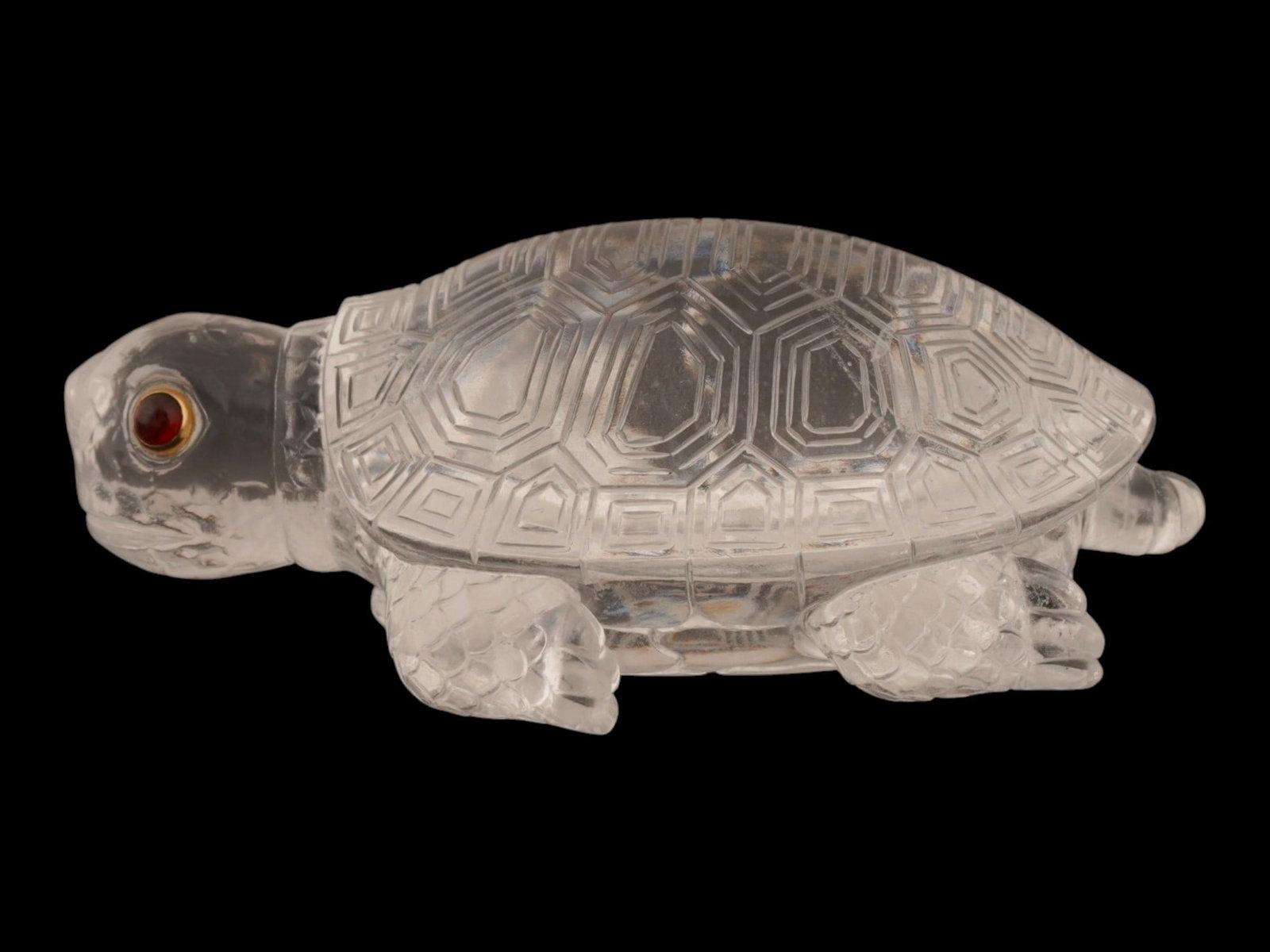 RUSSIAN ROCK CRYSTAL TURTLE FIGURE W GOLD GEMSTONE EYES: A Russian hardstone figure depicting a turtle carved from Rock Crystal with detailed engravings. The head features two cabochon gemstones set within gold mounts to form the eyes. Russian Hardstone
