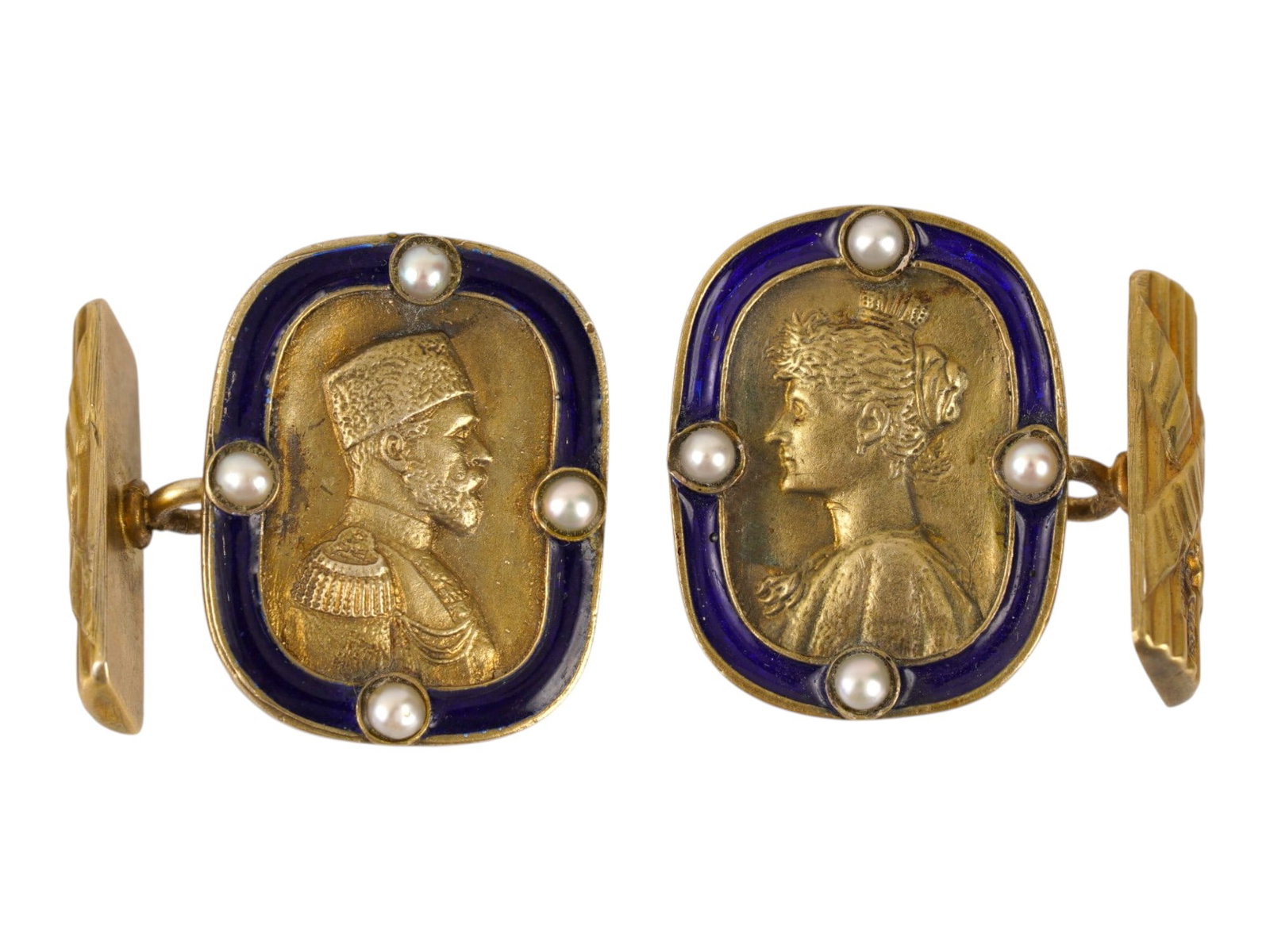RUSSIAN SILVER ENAMEL NICHOLAS II CUFFLINKS WITH PEARLS: A pair of Russian gilt-silver and enamel cufflinks featuring profile portraits of Emperor Nicholas II and Empress Alexandra Feodorovna. Each portrait is framed by cobalt blue enamel and accented with 