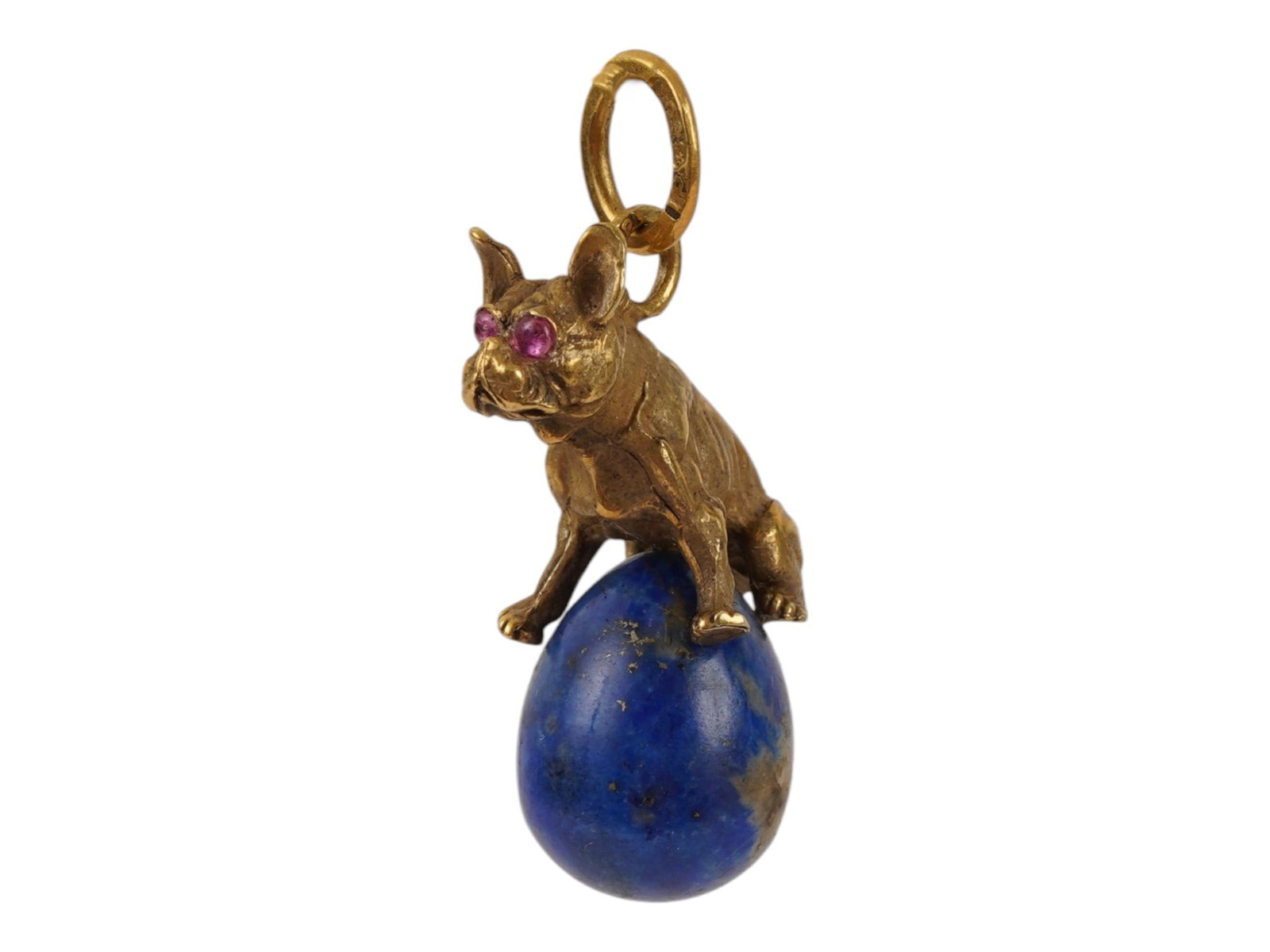 RUSSIAN SILVER AND LAPIS LAZULI DOG EASTER EGG PENDANT: A Russian carved lapis lazuli Easter Egg pendant. Topped with a gilt silver bulldog figurine with ruby eyes. Hallmark of 84 silver standard and makers mark are on the fitting ring. Total Weight: 11 g.