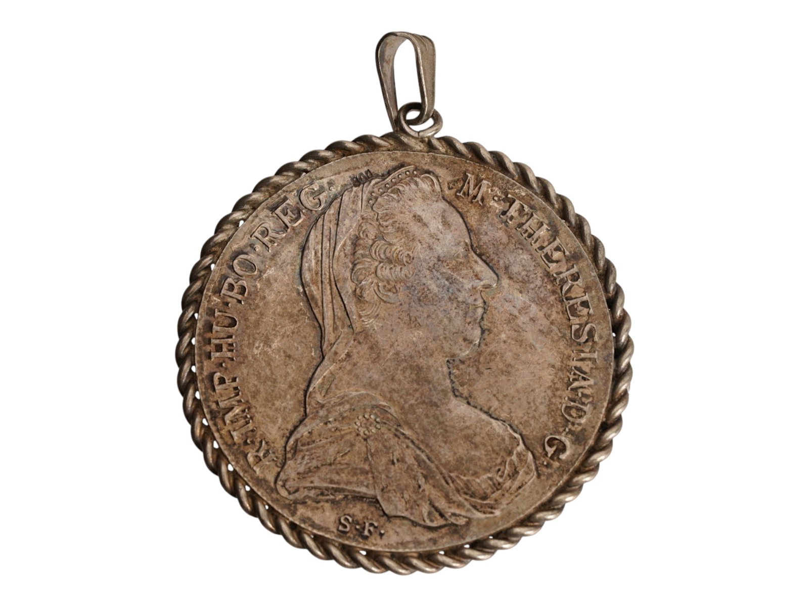 ANTIQUE 1780 SILVER MARIA THERESA THALER COIN PENDANT: A large antique pendant, made from an Austrian silver Maria Theresa thaler coin from 1780. Twisted rope decoration around the rim. Hanging ring at the top. Silver Jewelry Wares and Accessories For