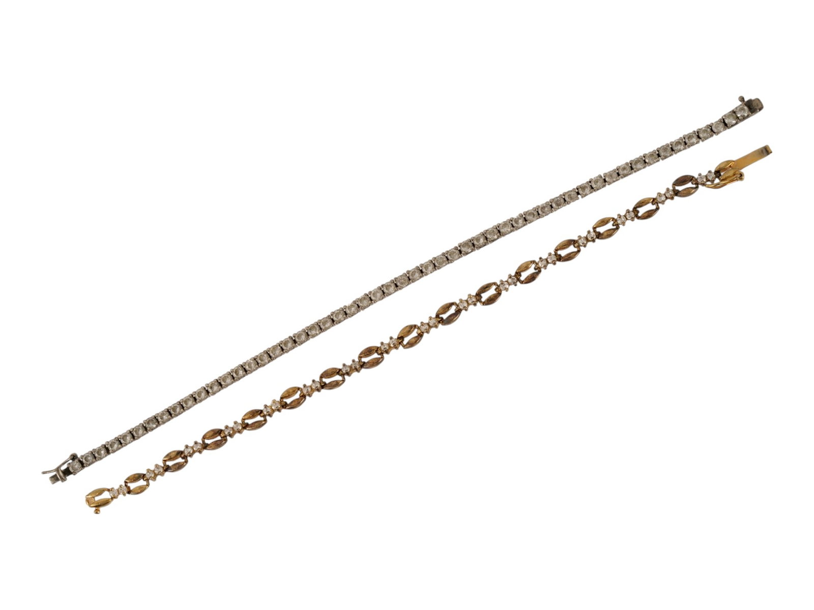 PAIR OF STERLING SILVER TENNIS BRACELETS: A pair of vintage sterling silver bracelets embellished with crystals. First. Classic tennis bracelet, marked 925 China PZ on the clasp. Second. Gilded link bracelet with alternating loop and double c