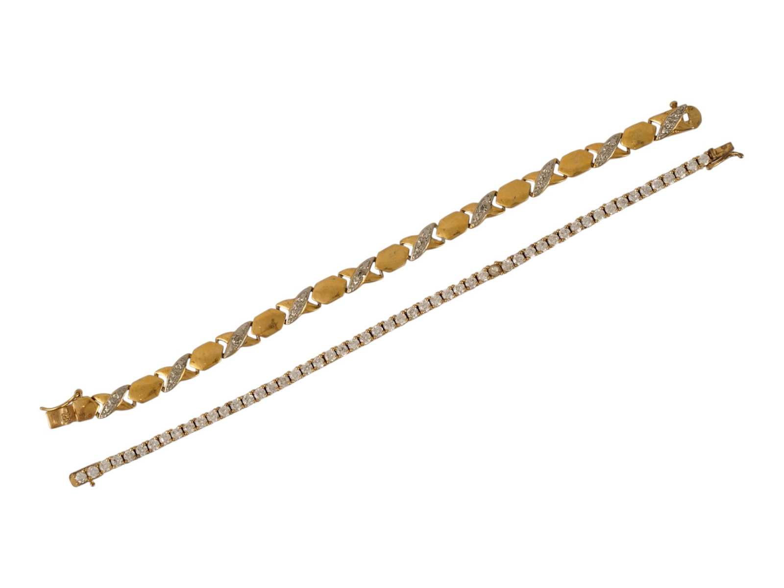 PAIR OF GILT STERLING SILVER TENNIS BRACELETS: A pair of vintage gilt sterling silver bracelets embellished with crystals. First. Classic tennis bracelet. Second. Gilded link bracelet with alternating hexagonal and jeweled X motives. Both are mark
