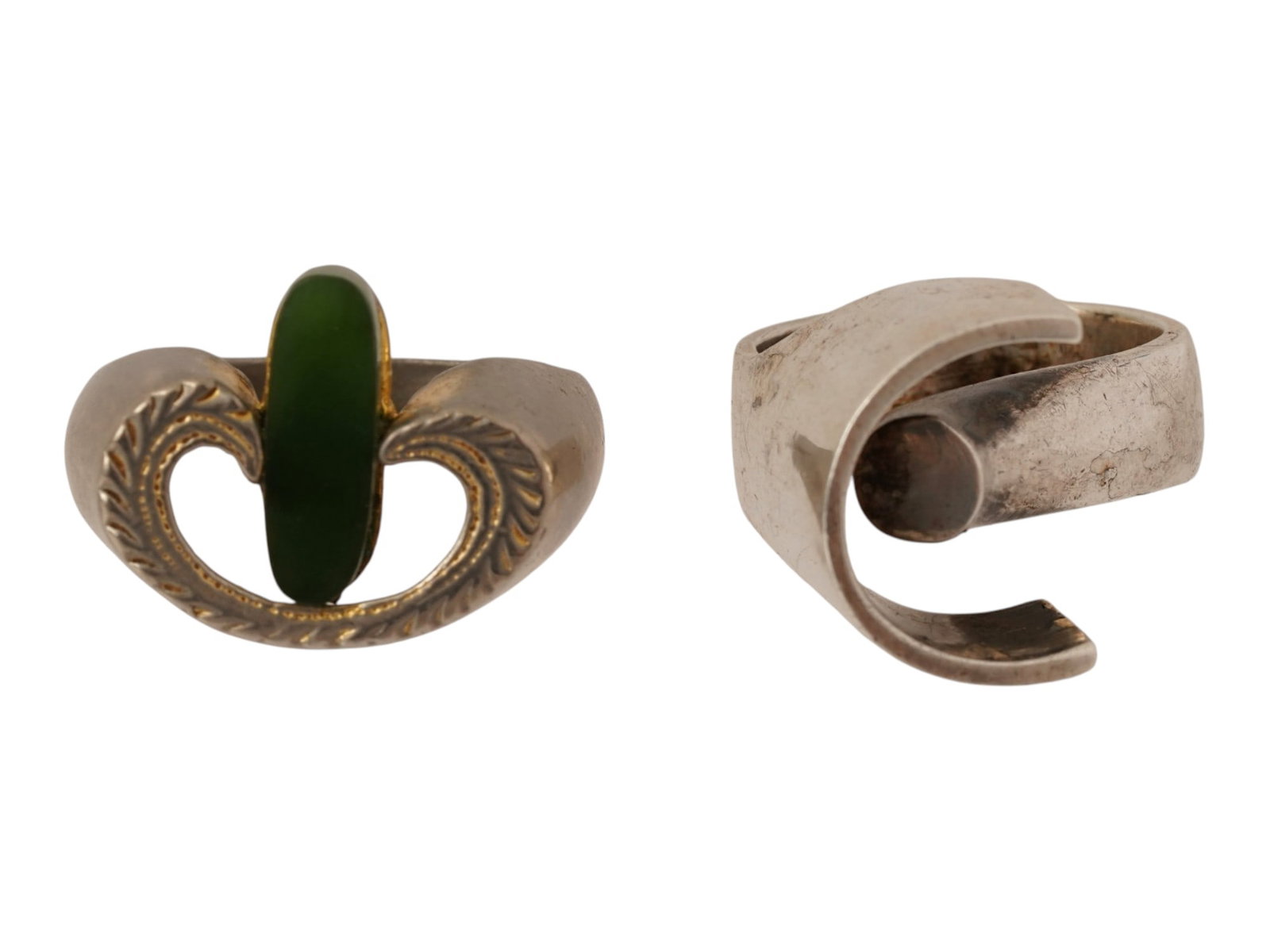 PAIR OF VINTAGE MODERNIST STERLING SILVER RINGS: A pair of vintage sterling silver rings of complex modernist design. One ring is set with a jade stone and marked Spain inside. Total Weight: 15 g. Vintage Statement Jewelry And Fashion Accessories.