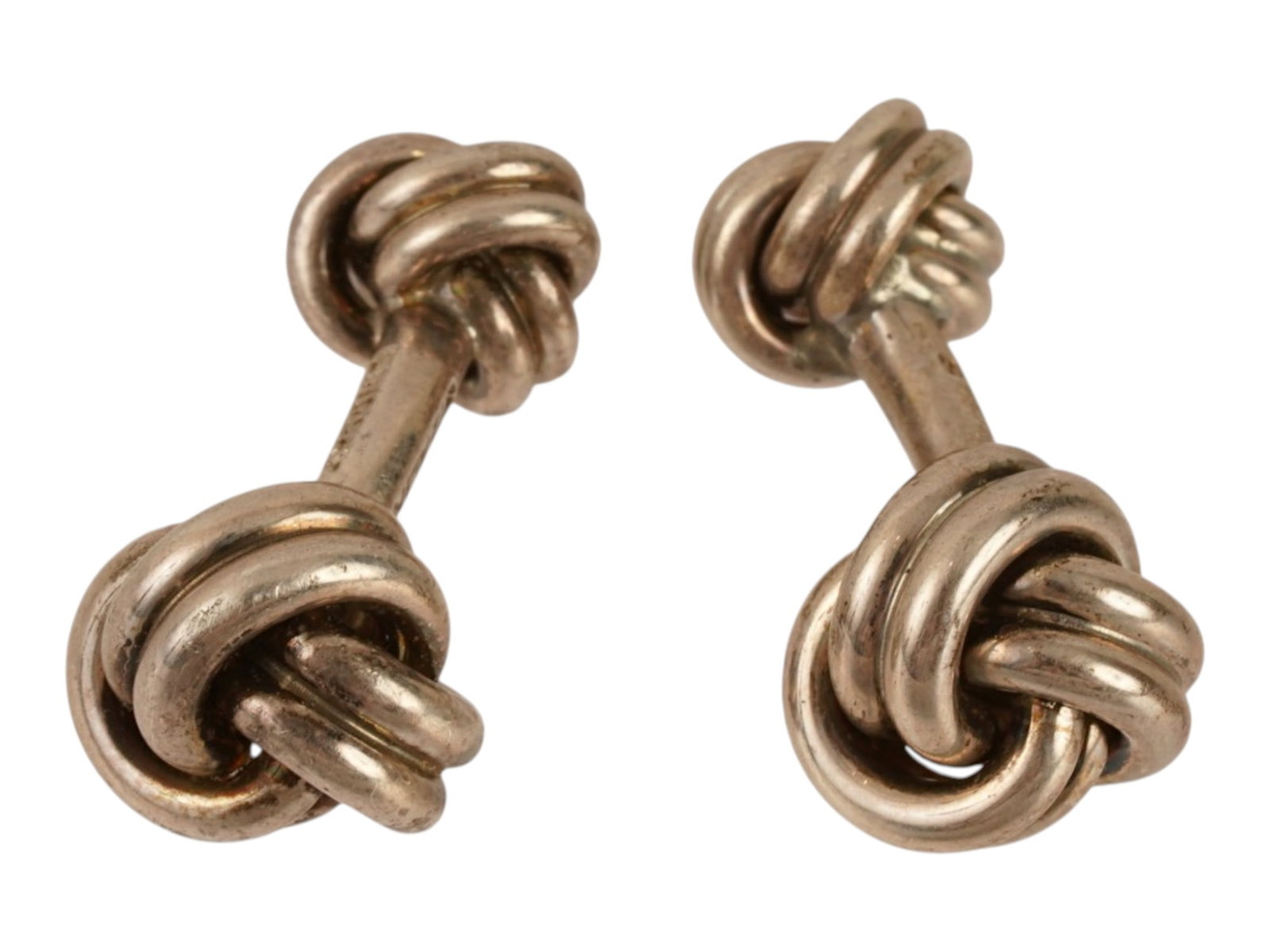 VINTAGE LINDSAY STERLING SILVER DOUBLE KNOT CUFFLINKS: A pair of vintage Lindsay and Co. sterling silver double-knot cufflinks. Each cufflink features matching monkeys fist or love knot terminals connected by curved fixed-bridge posts. Marked. Vintage