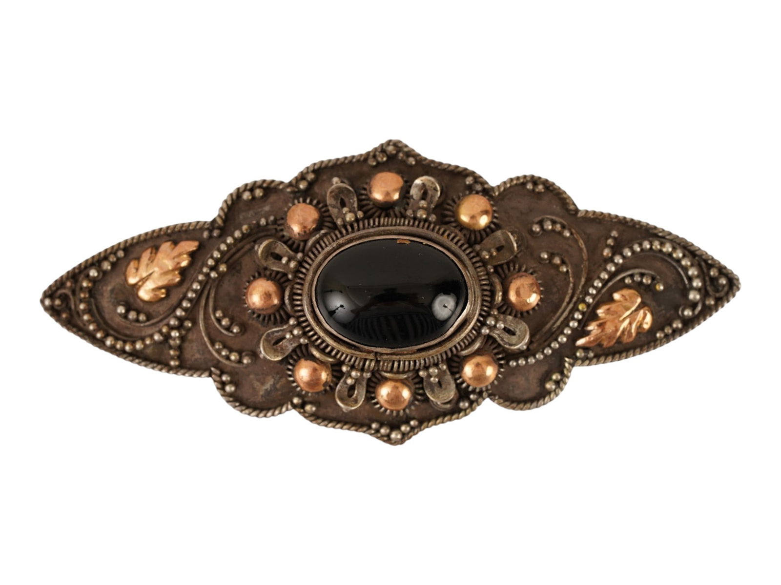 ANTIQUE 14K GOLD AND STERLING SILVER FILIGREE BROOCH: An antique brooch crafted in sterling silver with 14K gold accents, featuring a central oval black onyx cabochon set within a complex filigree framework. The design incorporates a navette silhouette w