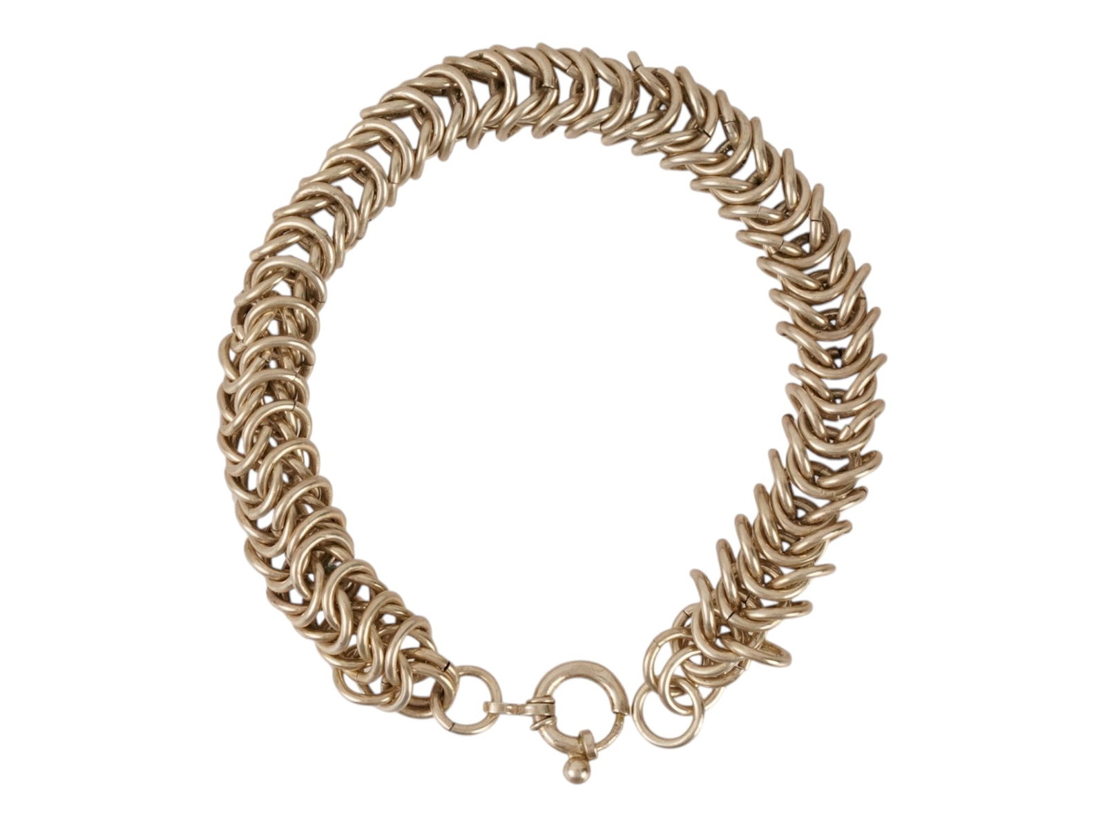 STERLING SILVER BYZANTINE WEAVE DESIGN LINK BRACELET: A sterling silver bracelet featuring a classic Byzantine weave, characterized by a dense and intricate arrangement of interlocking circular links. The piece is secured with a polished spring ring clas