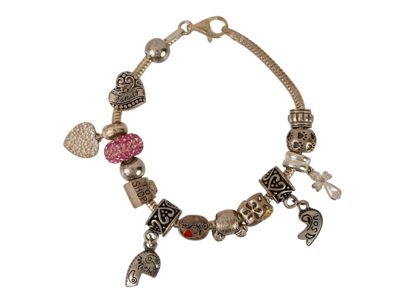 ITALIAN 925 STERLING SILVER CHARM BRACELET MARKED: A sterling silver charm bracelet featuring a flexible snake chain secured by a lobster claw clasp hallmarked 925 and an Italy mark. The assembly includes a variety of decorative elements, including a 