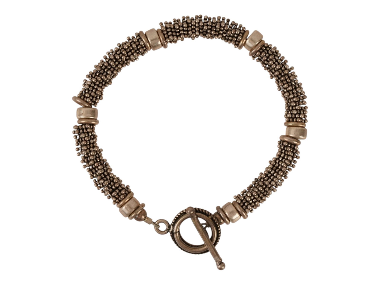 VINTAGE STERLING SILVER BEADED MESH LOOP BRACELET: A vintage sterling silver beaded mesh multi-strand loop bracelet, featuring an intricate woven body with numerous textured silver nodes. The bracelet is accented with six smooth cylindrical spacer rin