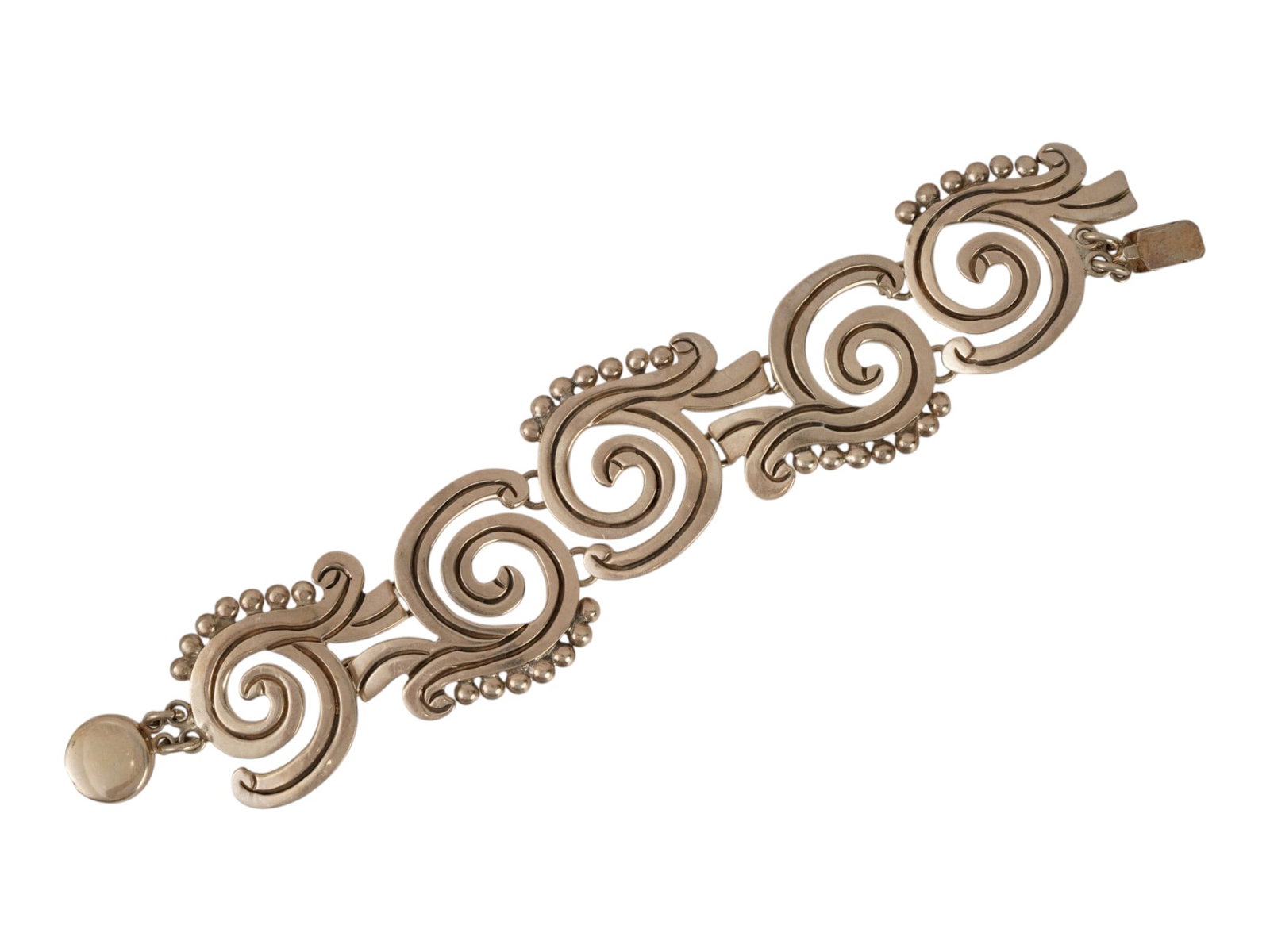 MEXICAN STERLING SILVER SWIRL LINK BRACELET: A Mexican sterling silver link bracelet. The links are designed as swirls or spirals with beaded rim. Marked 925 on the clasp. Weight: 64.5 g. Vintage Jewelry And Fashion Accessories. THIS LOT IS ELIG