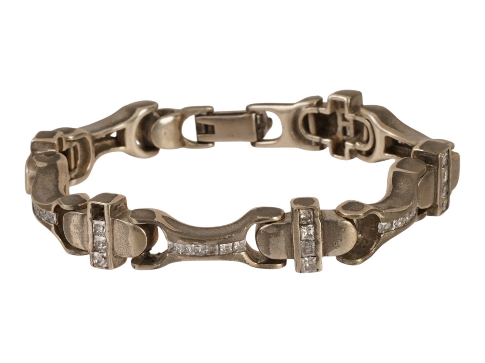VINTAGE STERLING SILVER GEMSTONE PANEL LINK BRACELET: A vintage sterling silver architectural sectional panel link bracelet decorated with rows of clear white gemstones. The bracelet features articulated geometric links, channel-set square stones, a fold