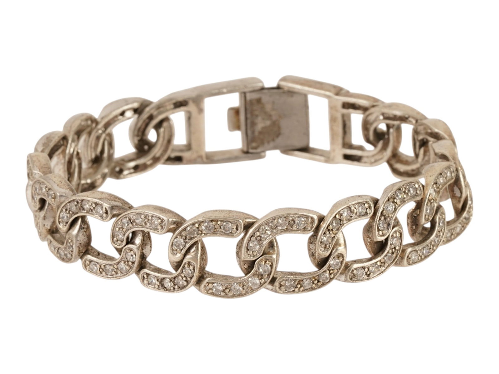LARGE CUBAN LINK STERLING SILVER BRACELET W GEMSTONES: A large Cuban link bracelet crafted from hallmarked 925 sterling silver. The bracelet features a continuous series of oval links pave set with numerous round cut clear gemstones. The piece is finished