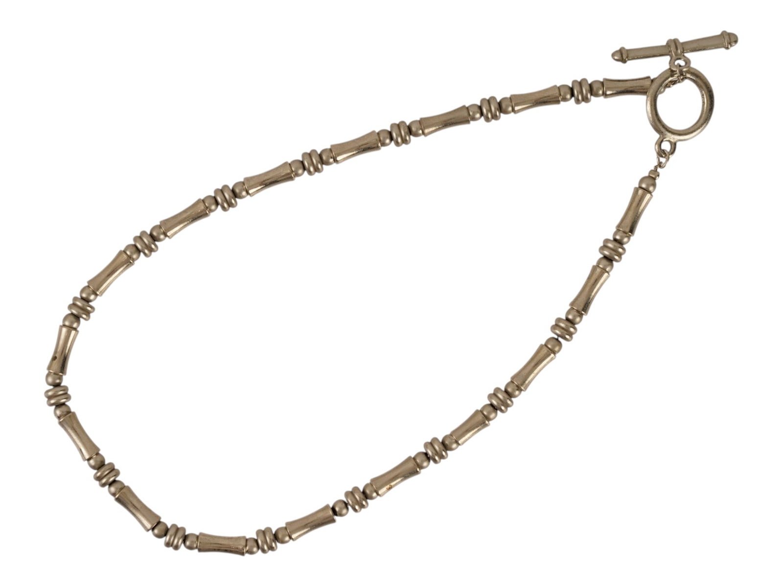 VINTAGE STERLING SILVER BAMBOO LINK COLLAR NECKLACE: A vintage sterling silver bamboo-link collar necklace in an organic modernist style. The necklace features segmented bamboo-form tube links separated by clusters of rounded bead spacers. Vintage Sterl