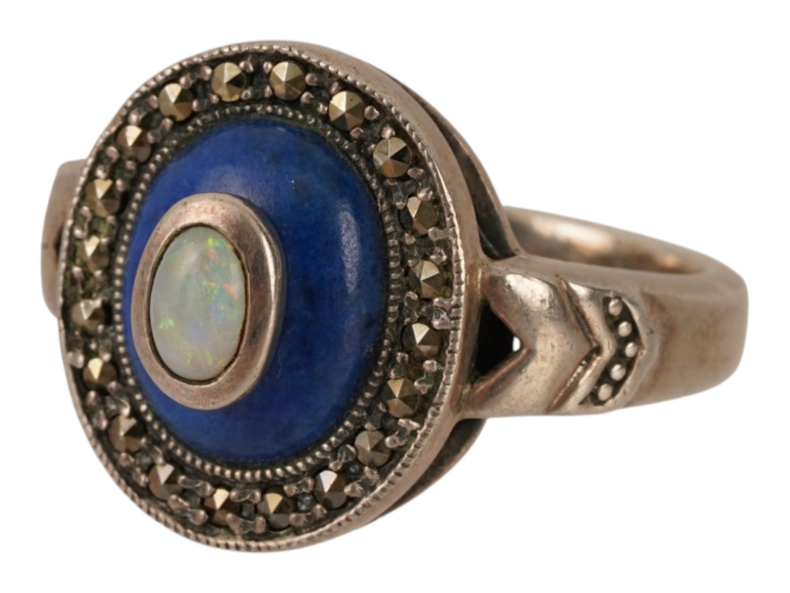 STERLING SILVER RING W LAPIS LAZULI AND MARCASITES: A vintage sterling silver ring with gemstones. The oval ring features lapis lazuli and an oval insert of a white stone with iridescent shimmer, possibly opal. A row of marcasite adorns the edge. Marke