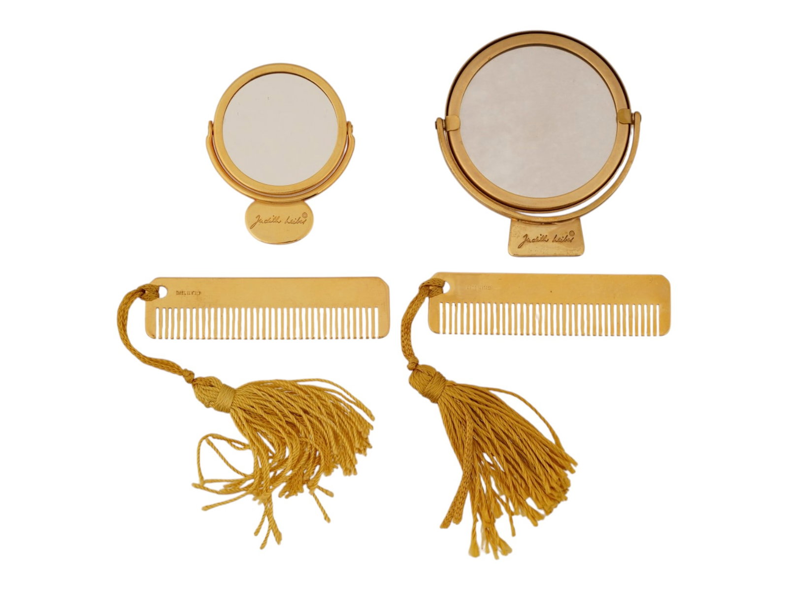 LOT OF JUDITH LEIBER GOLD TONE COMBS AND MIRRORS: Two sets of vanity items by Judith Leiber, each including a compact mirror with stand and a hair comb. Gold-tone metal, the combs are decorated with matching tassels. Each piece is marked Judith Leibe