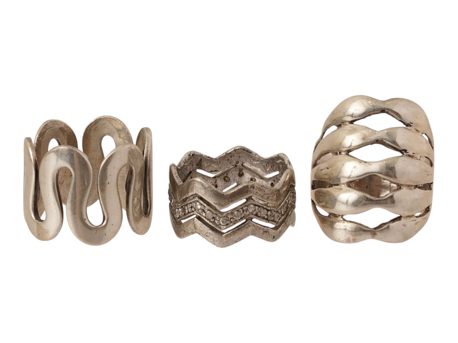 LOT OF VINTAGE MODERNIST STERLING SILVER RINGS: A lot of three vintage sterling silver statement rings. Zigzag and swirl designs, one ring is embellished with crystals. Each piece is marked 925 inside. Vintage Modernist Jewelry And Fashion Accessor