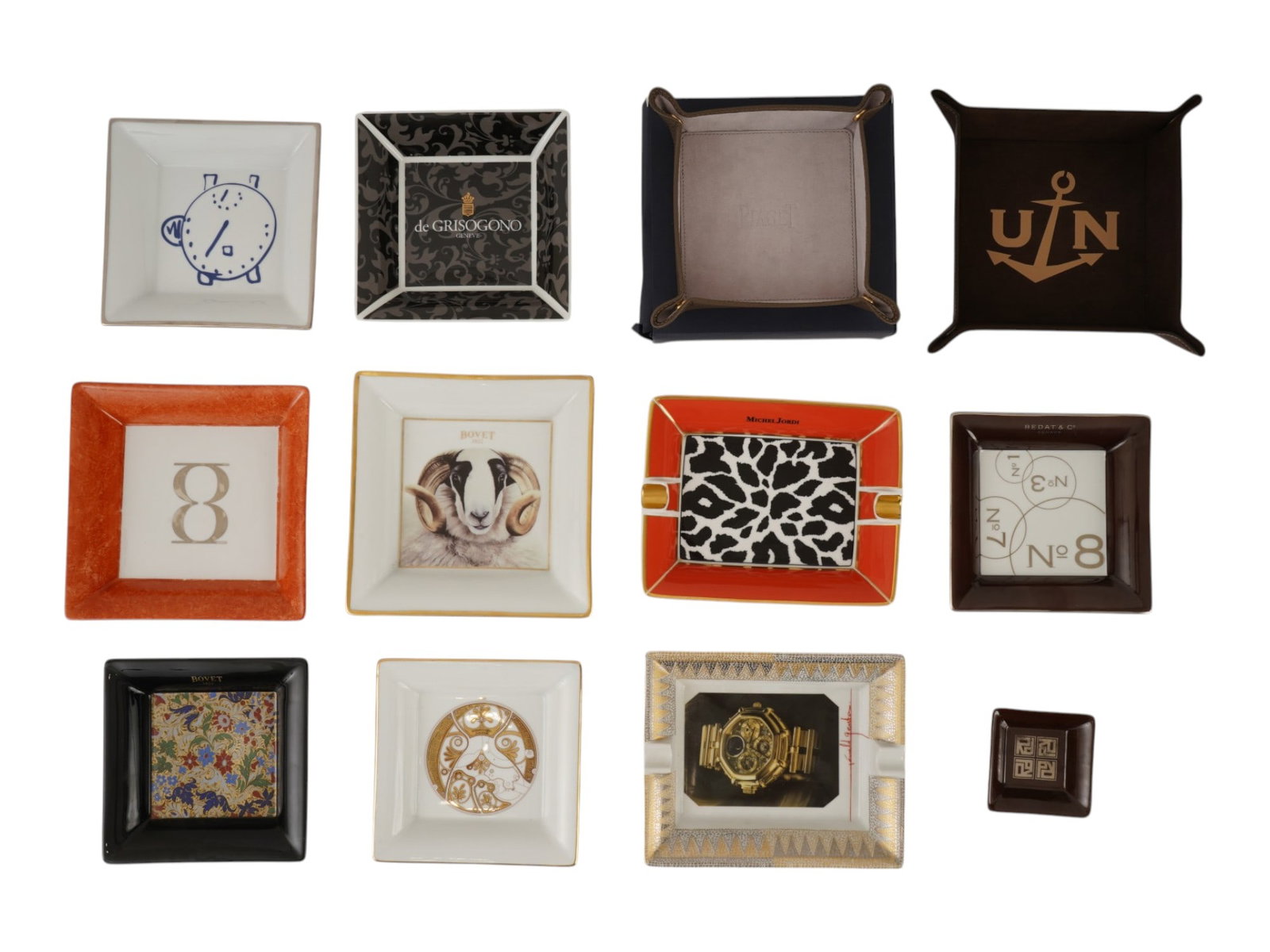 COLLECTION OF ASHTRAYS BY ULYSSE NARDIN PIAGET BOVET: A lot of 12 vintage porcelain ashtrays and trinket dishes by luxury watch brands. Including pieces by Bovet, Michel Jordi, Bedat And Co., Piaget, Ulysse Nardin, Gerald Genta, Roger Dubuis, de Grisogon