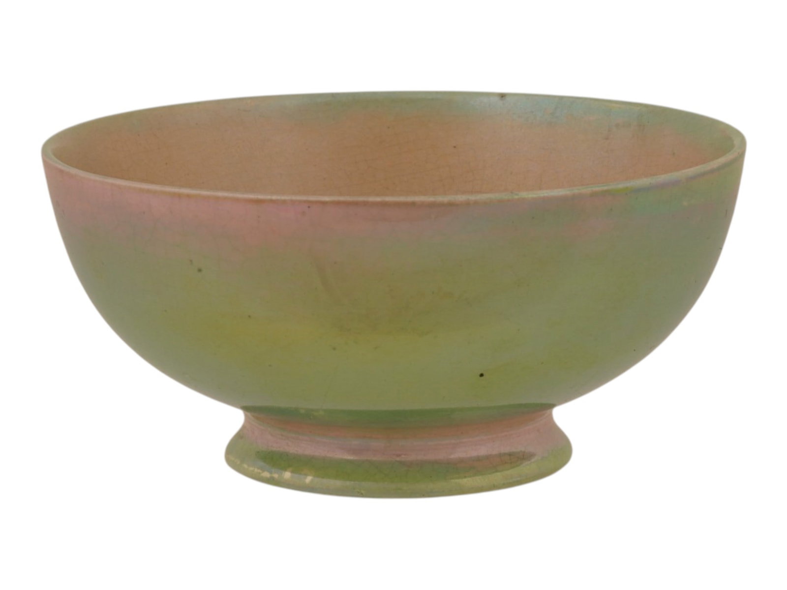 MOORCROFT ENGLISH LUSTRE GLAZE FOOTED PORCELAIN BOWL: A Moorcroft footed porcelain bowl featuring a distinctive two tone iridescent lustre glaze, presenting a pale sage green exterior and a contrasting salmon pink interior. The underside of the base bear