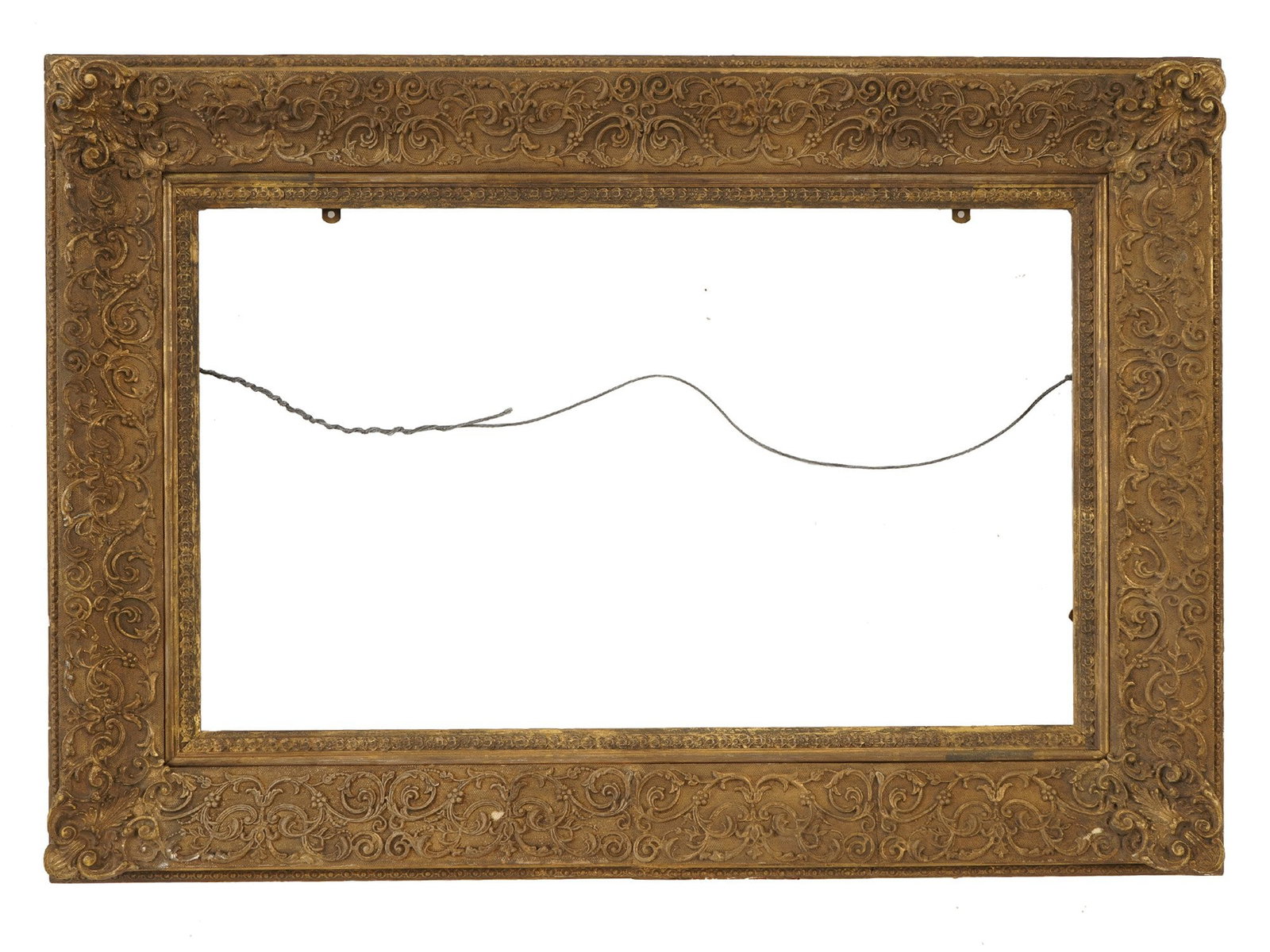 ANTIQUE EUROPEAN BAROQUE GILT WOOD GESSO PICTURE FRAME: An antique European Baroque style gilt wood and gesso picture frame, dating from the late 18th or early 19th century. The frame features a wide recessed reverse-profile molding with prominent carved s