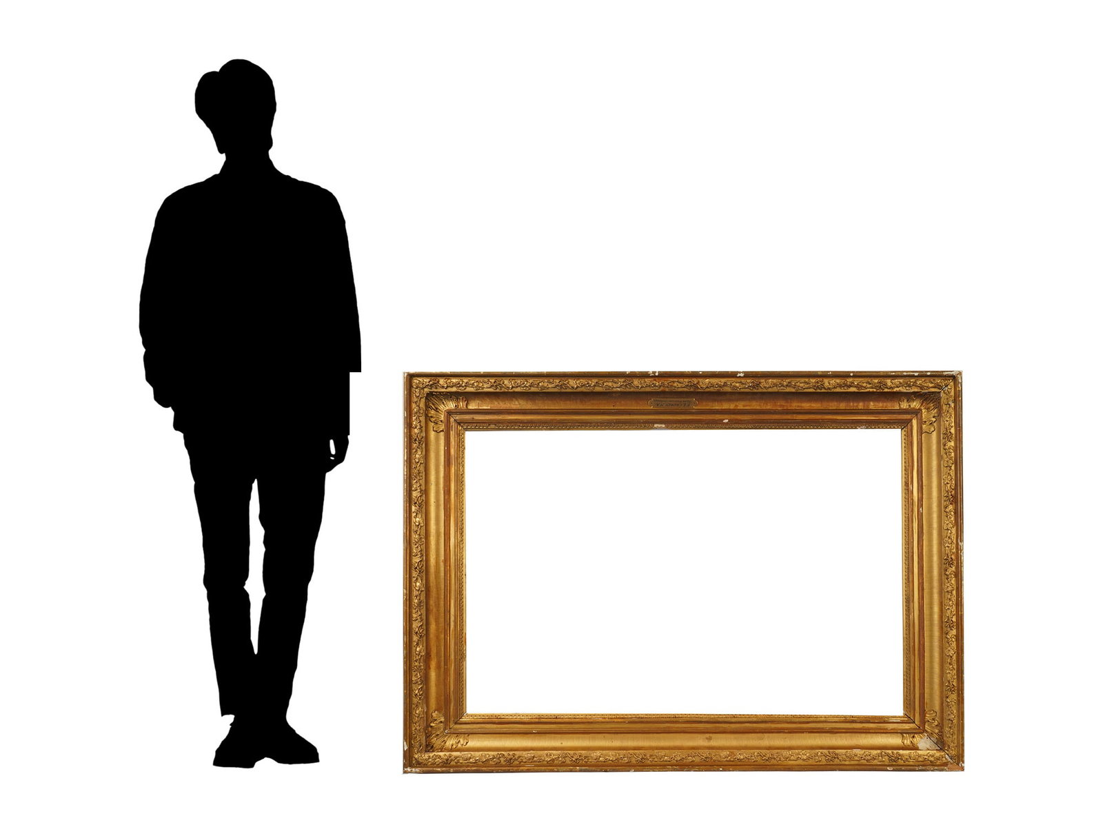 LARGE ANTIQUE AMERICAN GILT COMPOSITION PICTURE FRAME: A large antique American gilt composition picture frame featuring a broad molded profile with high-relief floral and foliate ornamentation along the inner and outer borders. Dating to the 19th century