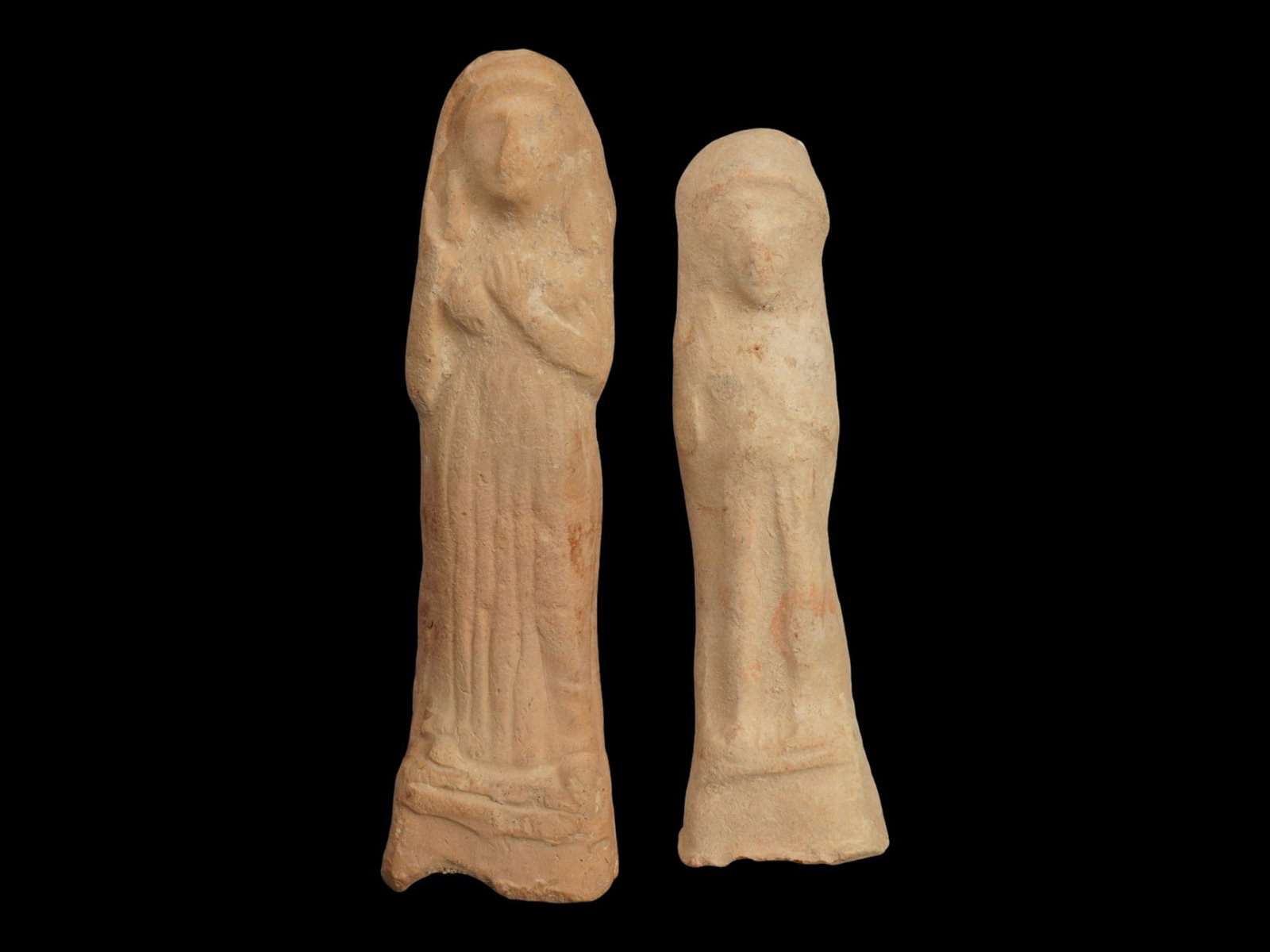 ANCIENT HOLY LAND TERRACOTTA FIGURINES 900 TO 700 BC: A lot of two ancient terracotta figurines from the Iron Age II period of the Holy Land, approximately 900 to 700 BC, representing the deities Astarte or Tanit related to Baal. Each figure is rendered 