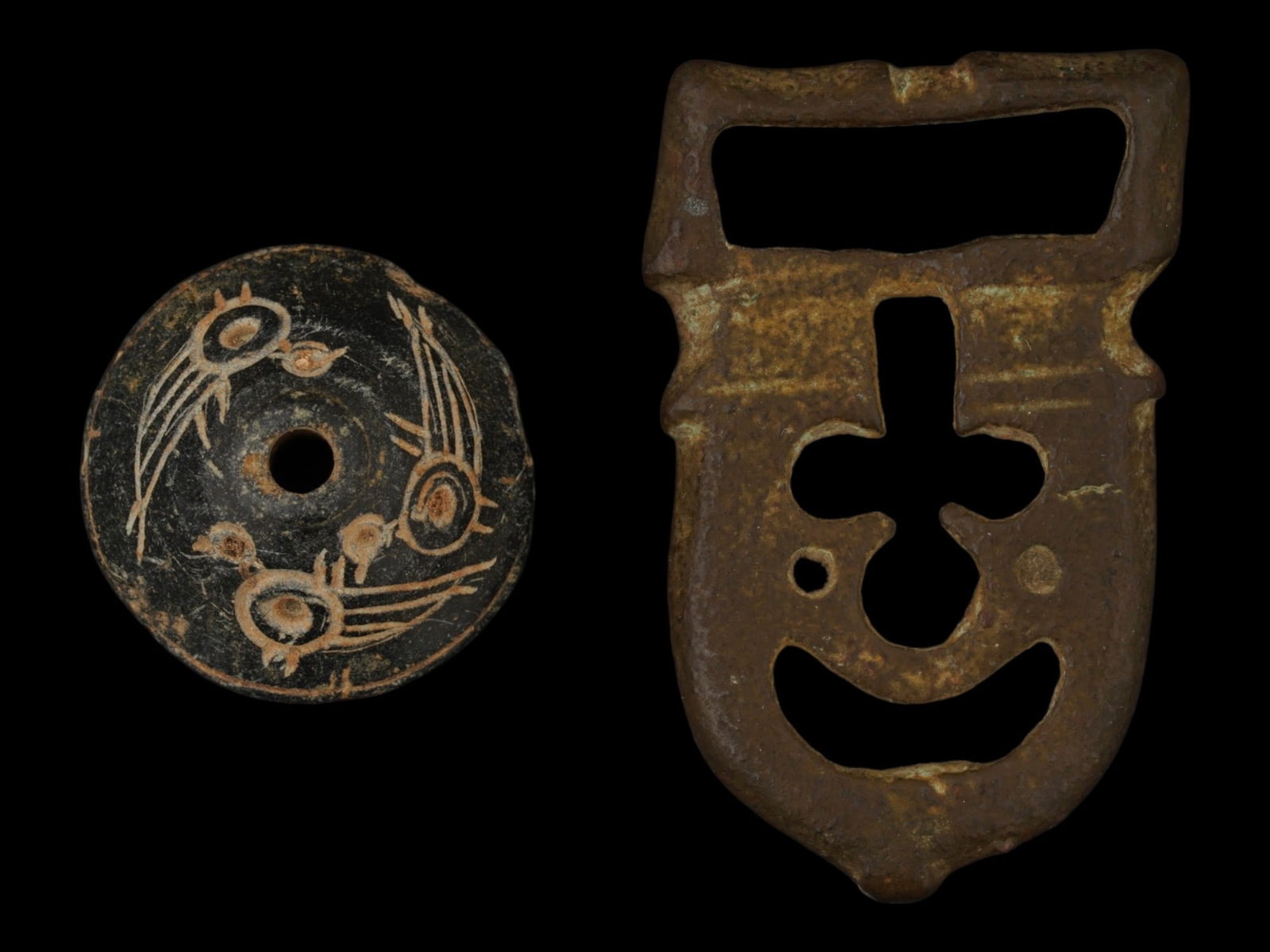 ANCIENT BYZANTINE BELT BUCKLE GRECO ROMAN SPINDLE WHORL: A collection of two ancient artifacts comprising a Byzantine bronze belt buckle and a Greco-Roman carved stone spindle whorl. The belt buckle, dating to circa 400 to 600 AD, is cast in the form of a t