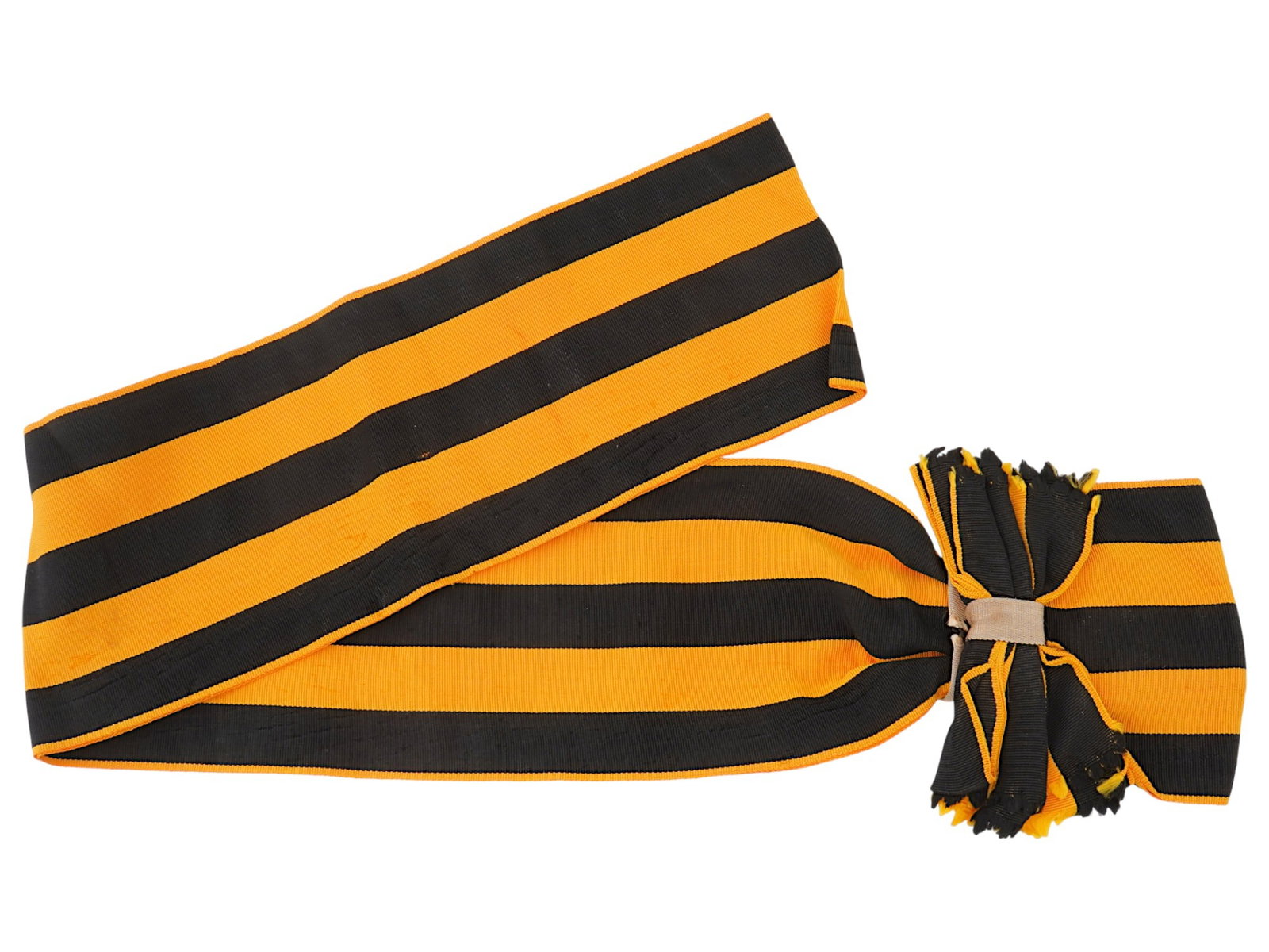 RUSSIAN IMPERIAL MILITARY ST GEORGE RIBBON: A Russian Imperial St. George ribbon, likely used for gartering weapons or awards. The woven ribbon features a design of red and black stripes topped with a bow. Historical Collectibles and Memorabili