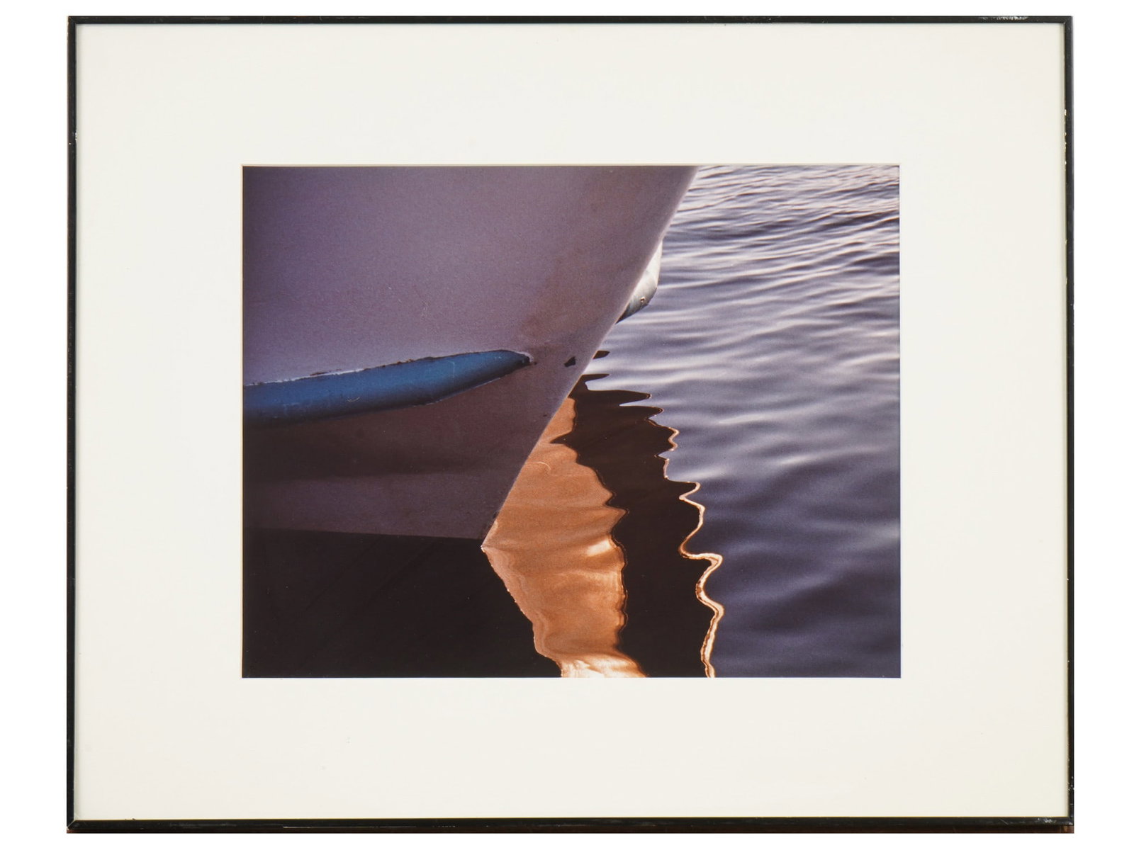 VINTAGE AMERICAN COLOR PHOTOGRAPH BY LOIS LIPPER: A vintage American color photograph by Lois Lipper. The photograph depicts an abstract composition consisting of a fragment of a boat on the water and its reflection. It is matted and framed. A paper 