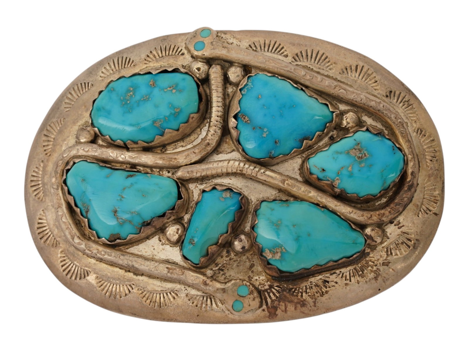 SNAKE DESIGN SILVER AND TURQUOISE BELT BUCKLE MARKED: A sterling silver belt buckle featuring a relief serpent motif winding around six large turquoise nuggets. The oval shaped buckle is accented with smaller turquoise stones serving as the snakes eyes, 